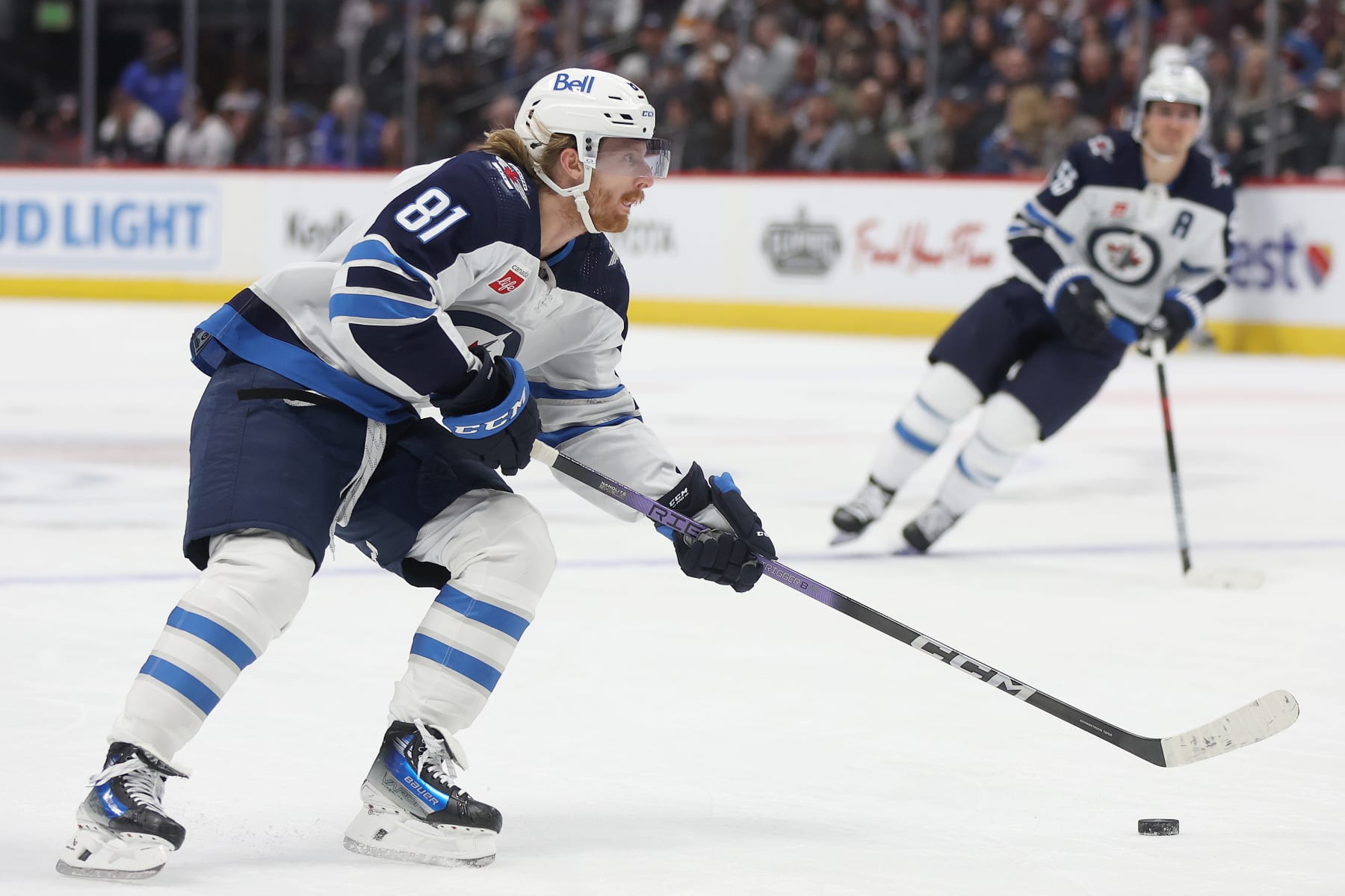 DENVER, COLORADO - DECEMBER 07: Kyle Connor #81 of the Winnipeg Jets looks for an opening against the Colorado Avalanche in the first period at Ball Arena on December 07, 2023 in Denver, Colorado. (Photo by Matthew Stockman/Getty Images)