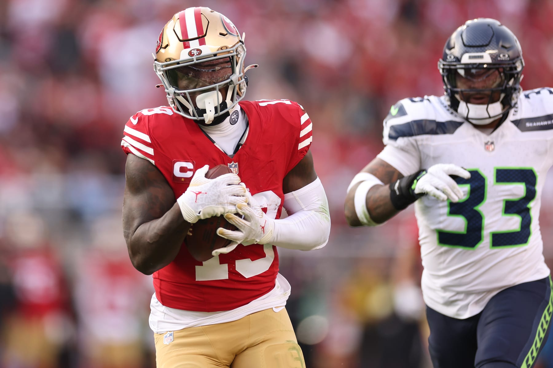 SANTA CLARA, CALIFORNIA - DECEMBER 10: Deebo Samuel #19 of the San Francisco 49ers catches a pass for a touchdown over Jamal Adams #33 of the Seattle Seahawks during the second quarter at Levi's Stadium on December 10, 2023 in Santa Clara, California. (Photo by Ezra Shaw/Getty Images)