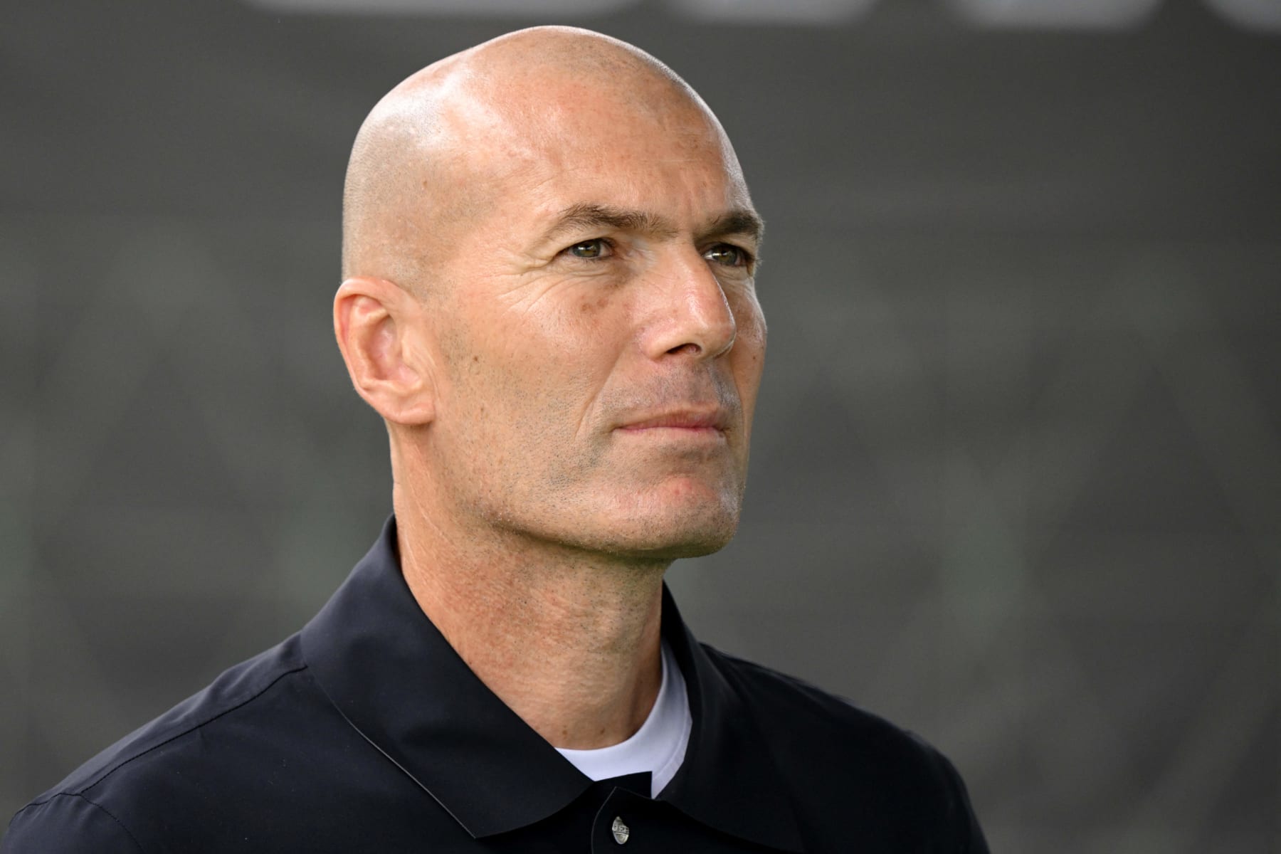 Former French footballer Zinedine Zidane looks on during a promotional day with gaming brand EA Sports at the Z5 sports complex in Aix-en-Provence, southern France, on June 21, 2023. Electronic Arts Inc announced FC FUTURES, a major programme to invest in community football worldwide with the aim of growing the sport for all. The programme will see investment over the next three years in a number of local football projects. This announcement follows the revelation by EA SPORTS of its new identity, new logo and new vision for the future of interactive football: EA SPORTS FC. (Photo by Nicolas TUCAT / AFP) (Photo by NICOLAS TUCAT/AFP via Getty Images)