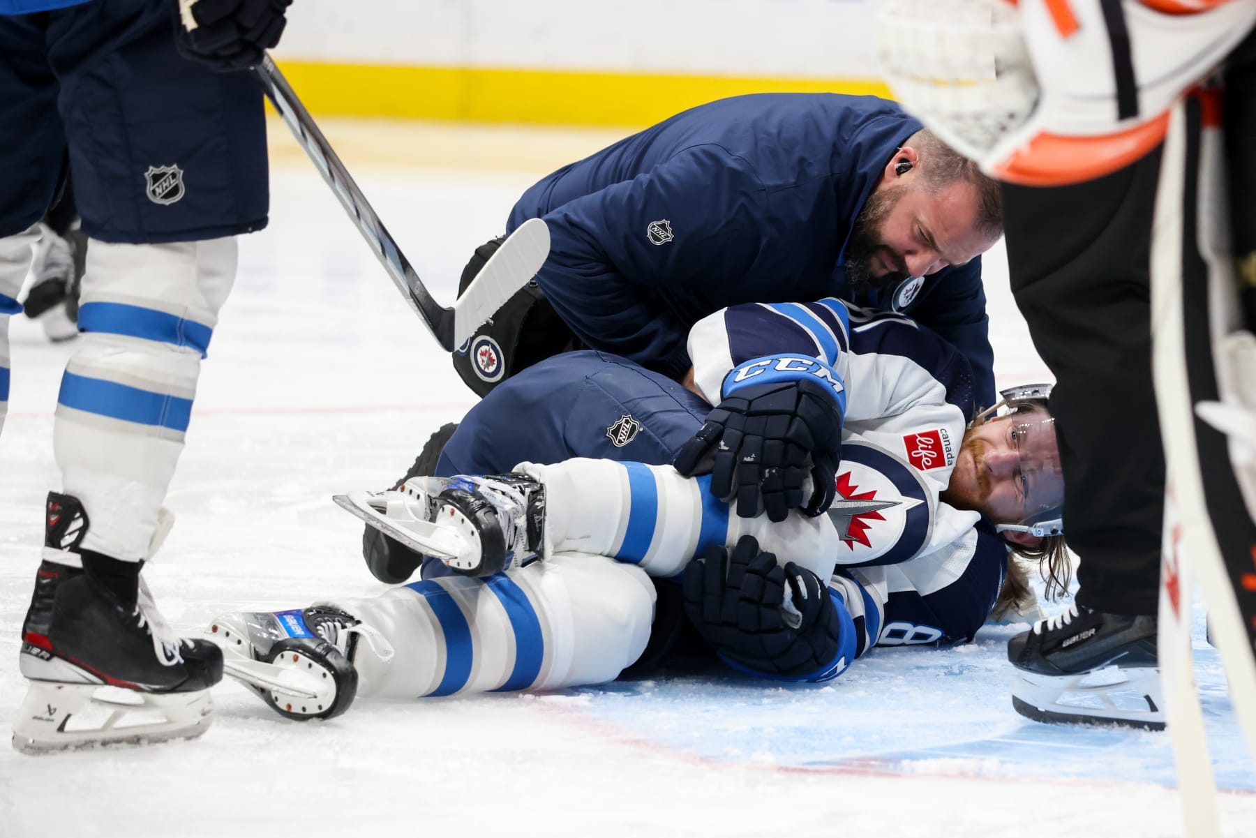 ANAHEIM, CA - DECEMBER 10: Kyle Connor #81 of the Winnipeg Jets falls to the ground after an apparent injury during the second period against the Anaheim Ducks at Honda Center on December 10, 2023 in Anaheim, California. (Photo by Debora Robinson/NHLI via Getty Images)