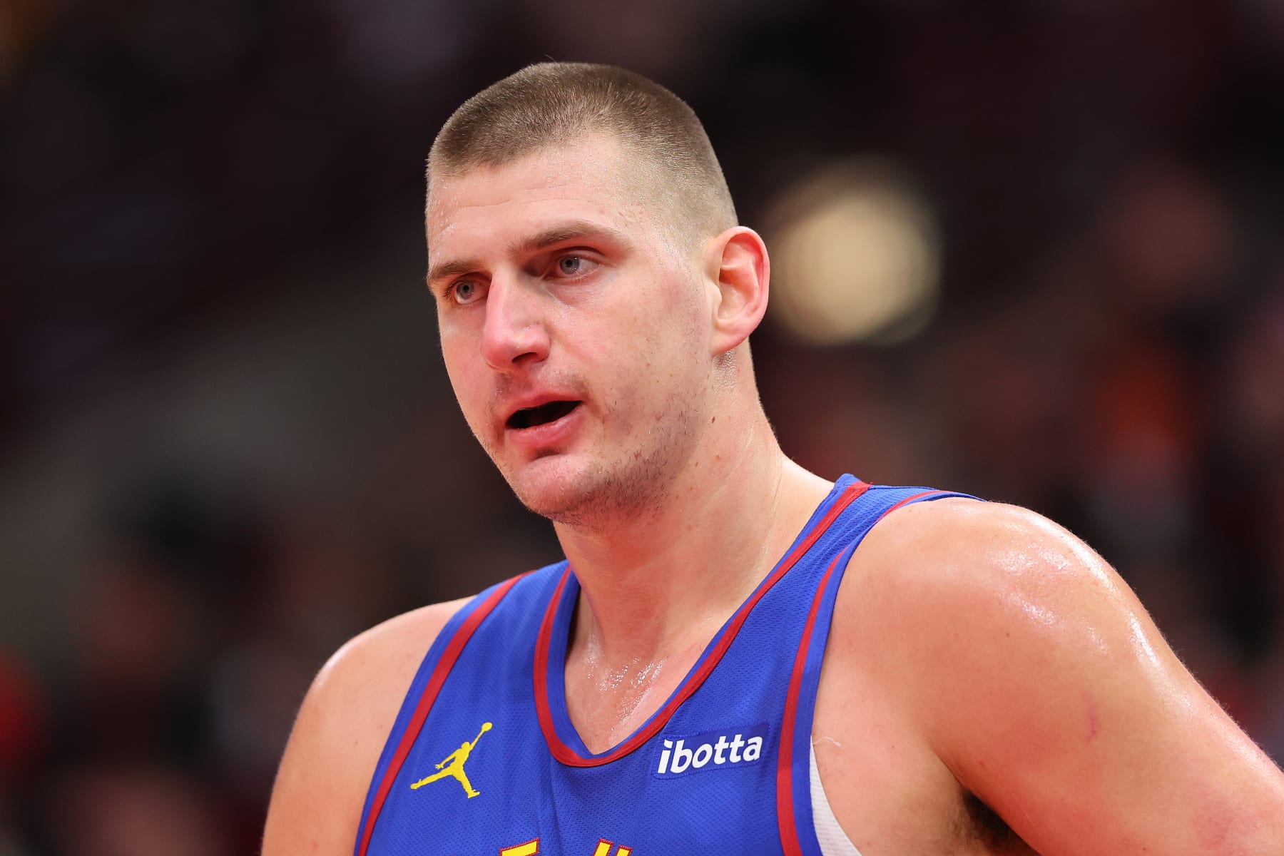 CHICAGO, ILLINOIS - DECEMBER 12: Nikola Jokic #15 of the Denver Nuggets reacts against the Chicago Bulls during the first half at the United Center on December 12, 2023 in Chicago, Illinois. NOTE TO USER: User expressly acknowledges and agrees that, by downloading and or using this photograph, User is consenting to the terms and conditions of the Getty Images License Agreement.  (Photo by Michael Reaves/Getty Images)