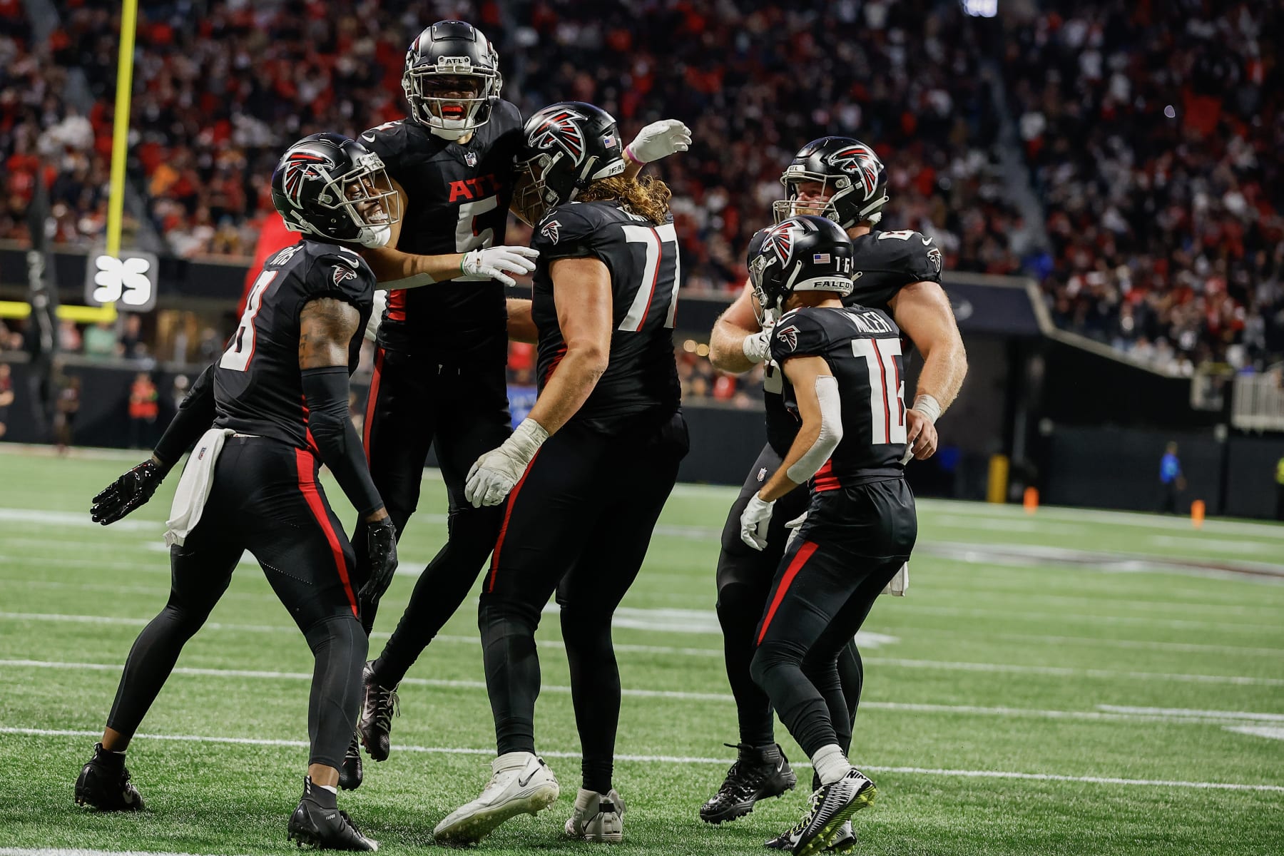 ATLANTA, GEORGIA - DECEMBER 10: Drake London #5 of the Atlanta Falcons reacts with teammates after a two point conversion during the second half of the game against the Tampa Bay Buccaneers at Mercedes-Benz Stadium on December 10, 2023 in Atlanta, Georgia. (Photo by Alex Slitz/Getty Images)