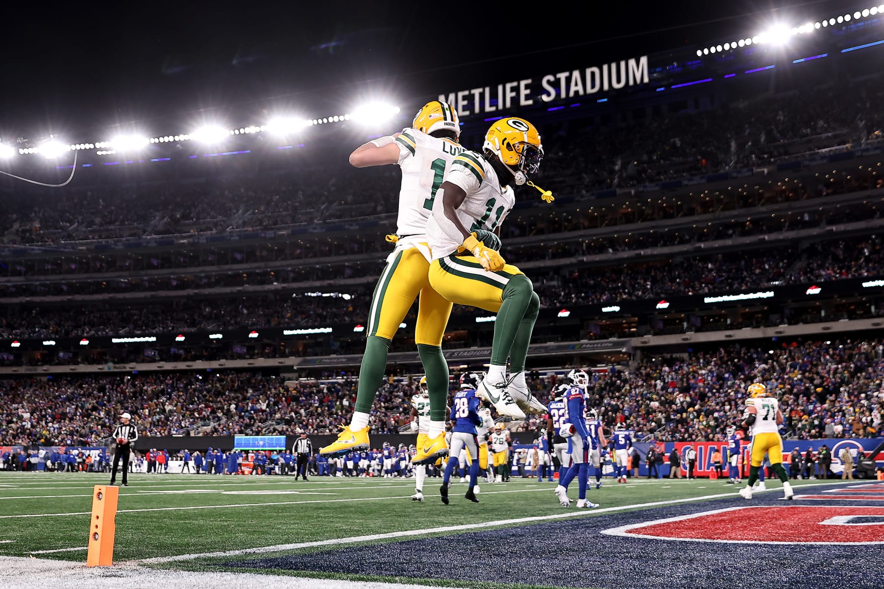 EAST RUTHERFORD, NEW JERSEY - DECEMBER 11: Jayden Reed #11 of the Green Bay Packers celebrates with Jordan Love #10 after scoring a 16 yard touchdown against the New York Giants during the first quarter in the game at MetLife Stadium on December 11, 2023 in East Rutherford, New Jersey. (Photo by Dustin Satloff/Getty Images)