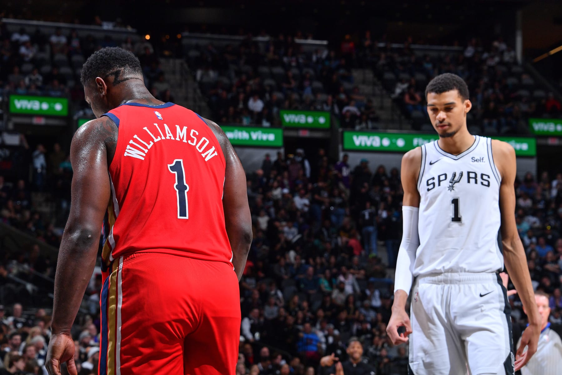 SAN ANTONIO, TX - DECEMBER 17: Zion Williamson #1 of the New Orleans Pelicans and Victor Wembanyama #1 of the San Antonio Spurs look on during the game on December 17, 2023 at the Frost Bank Center in San Antonio, Texas. NOTE TO USER: User expressly acknowledges and agrees that, by downloading and or using this photograph, user is consenting to the terms and conditions of the Getty Images License Agreement. Mandatory Copyright Notice: Copyright 2023 NBAE (Photos by Michael Gonzales/NBAE via Getty Images)
