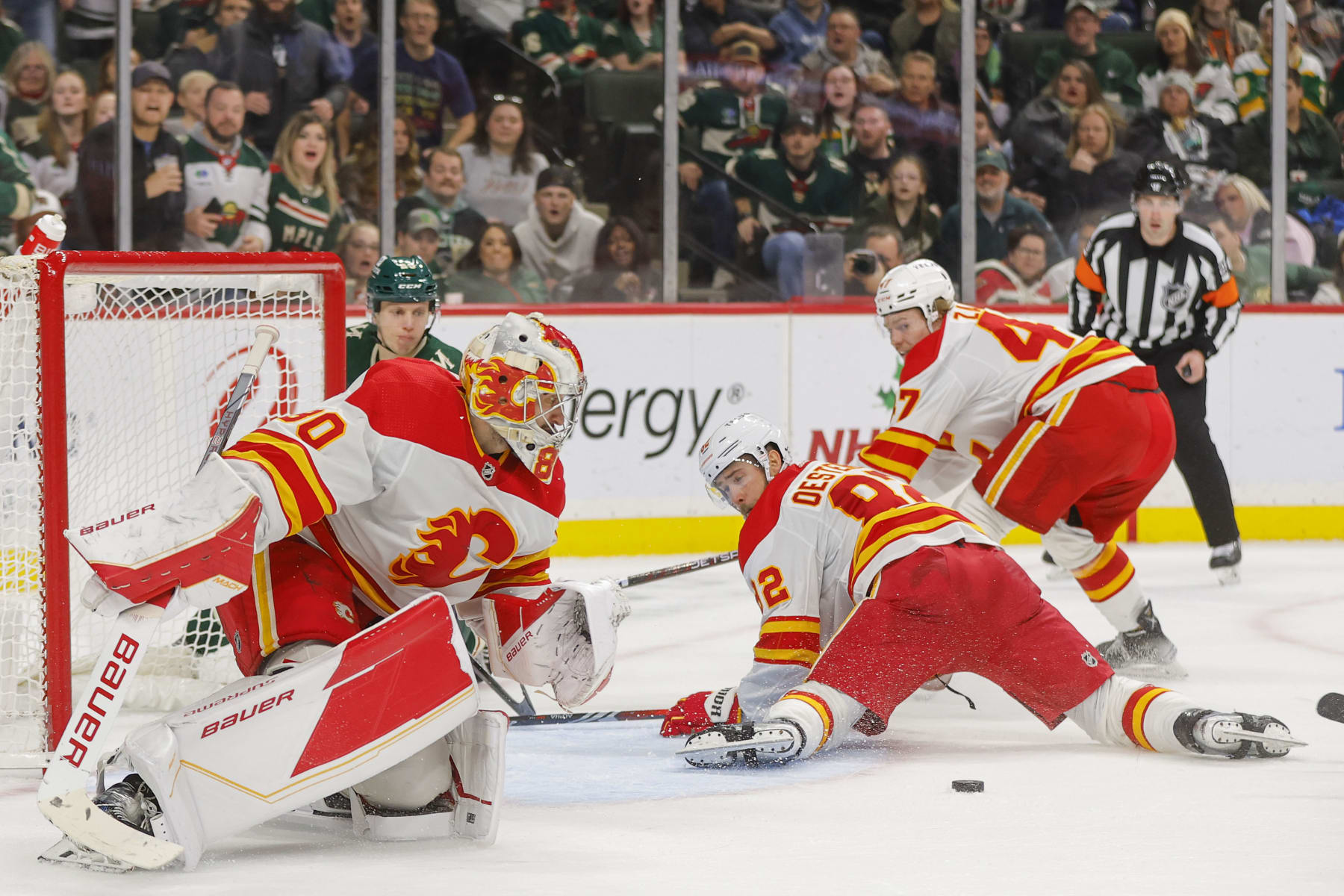SAINT PAUL, MN - DECEMBER 14: Dan Vladar #80 and Jordan Oesterle #82 of the Calgary Flames defend their goal against the Minnesota Wild during the game at the Xcel Energy Center on December 14, 2023 in Saint Paul, Minnesota. (Photo by Bruce Kluckhohn/NHLI via Getty Images)