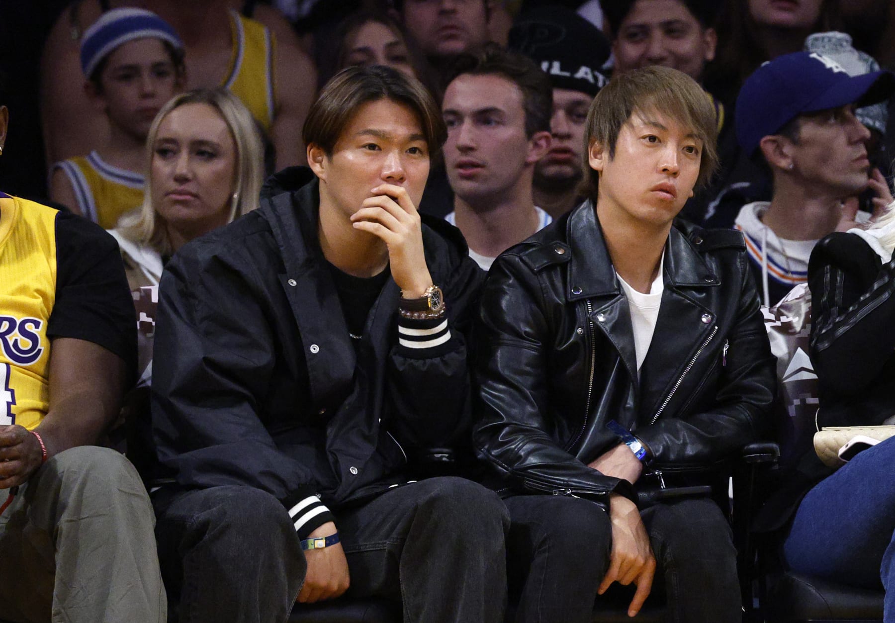 LOS ANGELES, CALIFORNIA - NOVEMBER 22: Japanese pitcher Yoshinobu Yamamoto (L) attends a basketball game between the Los Angeles Lakers and the Dallas Mavericks at Crypto.com Arena on November 22, 2023 in Los Angeles, California. NOTE TO USER: User expressly acknowledges and agrees that, by downloading and or using this photograph, User is consenting to the terms and conditions of the Getty Images License Agreement. (Photo by Kevork Djansezian/Getty Images)