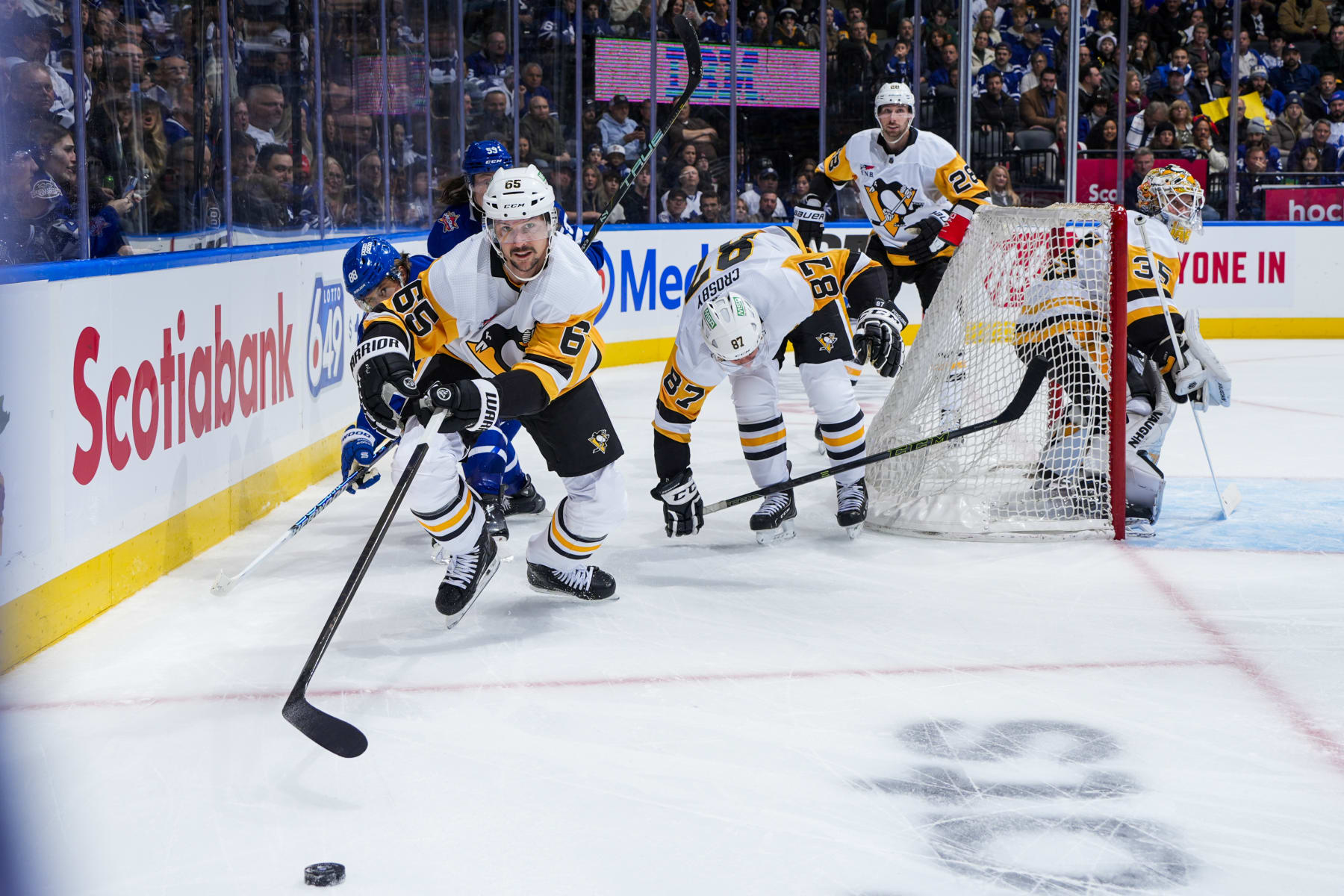 TORONTO, ON - DECEMBER 16: Erik Karlsson #65 of the Pittsburgh Penguins reaches for the puck against the Toronto Maple Leafs during the first period at the Scotiabank Arena on December 16, 2023 in Toronto, Ontario, Canada. (Photo by Mark Blinch/NHLI via Getty Images)