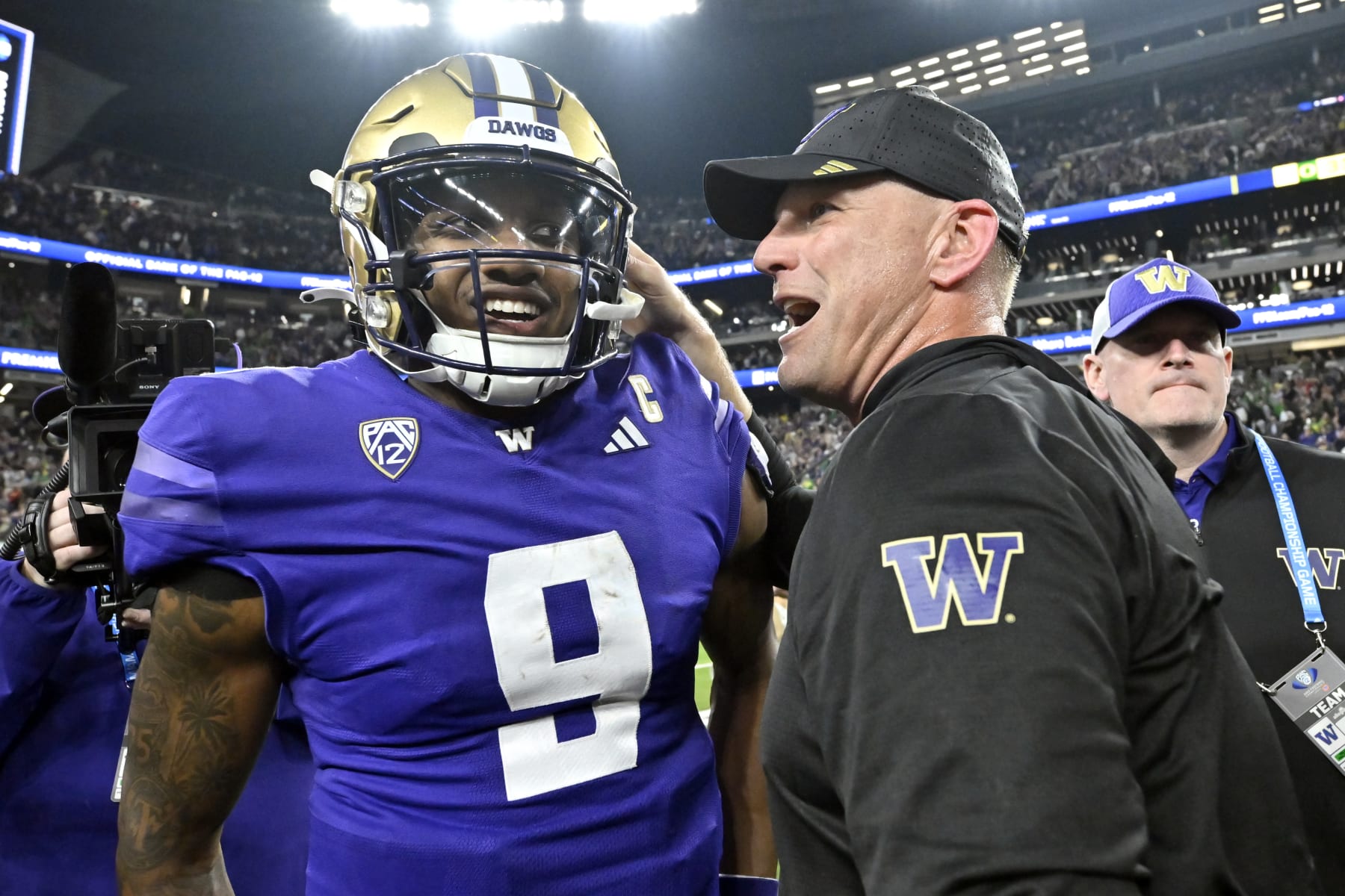 Washington quarterback Michael Penix Jr. and coach Kalen DeBoer talk after the team's victory against Oregon in the Pac-12 championship NCAA college football game Friday, Dec. 1, 2023, in Las Vegas. (AP Photo/David Becker)
