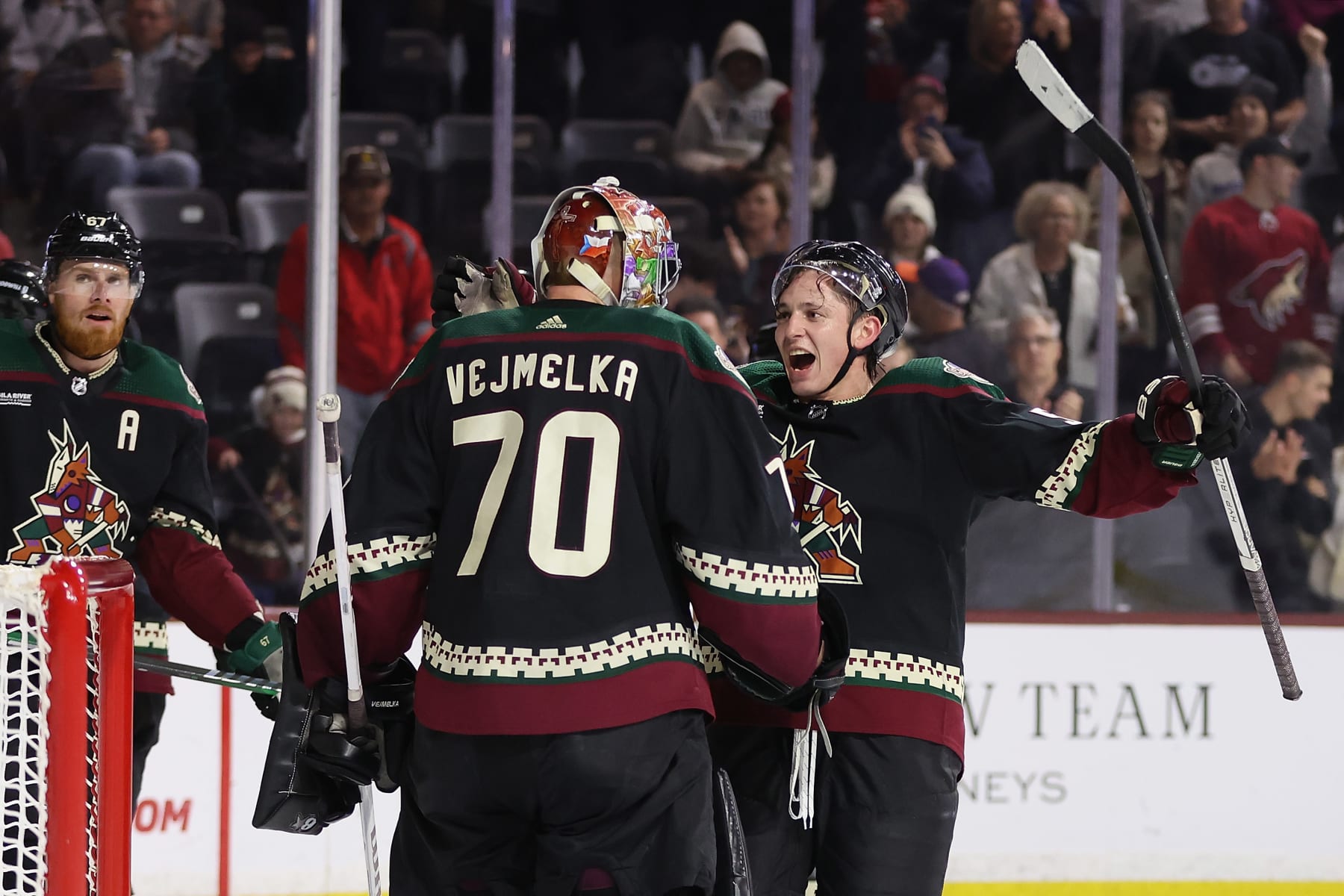 TEMPE, ARIZONA - DECEMBER 19: Troy Stecher #51 of the Arizona Coyotes celebrates with goaltender Karel Vejmelka #70 after defeating the Ottawa Senators in the NHL game at Mullett Arena on December 19, 2023 in Tempe, Arizona. The Coyotes defeated the Senators 4-3. (Photo by Christian Petersen/Getty Images)