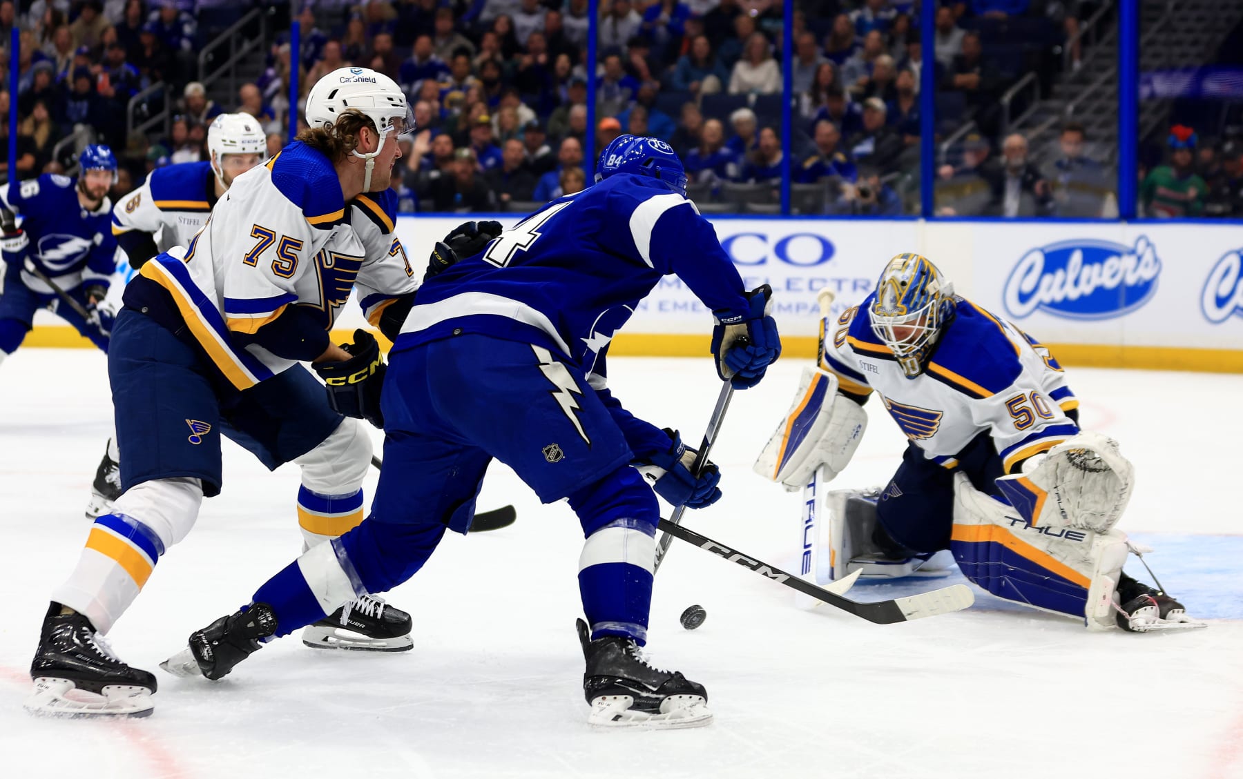 TAMPA, FLORIDA - DECEMBER 19: Jordan Binnington #50 of the St. Louis Blues stops a shot from Tanner Jeannot #84 of the Tampa Bay Lightning in the second period during a game at Amalie Arena on December 19, 2023 in Tampa, Florida. (Photo by Mike Ehrmann/Getty Images)