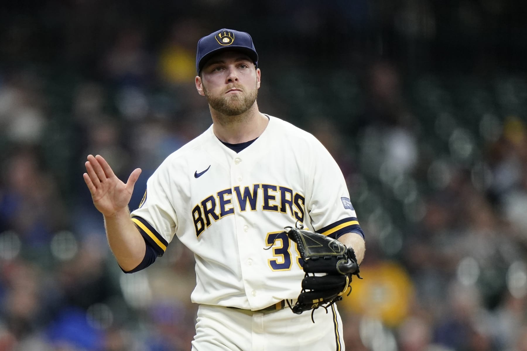 Milwaukee Brewers' Corbin Burnes reacts as he walks to the dugout during the fourth inning of a baseball game against the St. Louis Cardinals, Thursday, Sept. 28, 2023, in Milwaukee. (AP Photo/Aaron Gash)