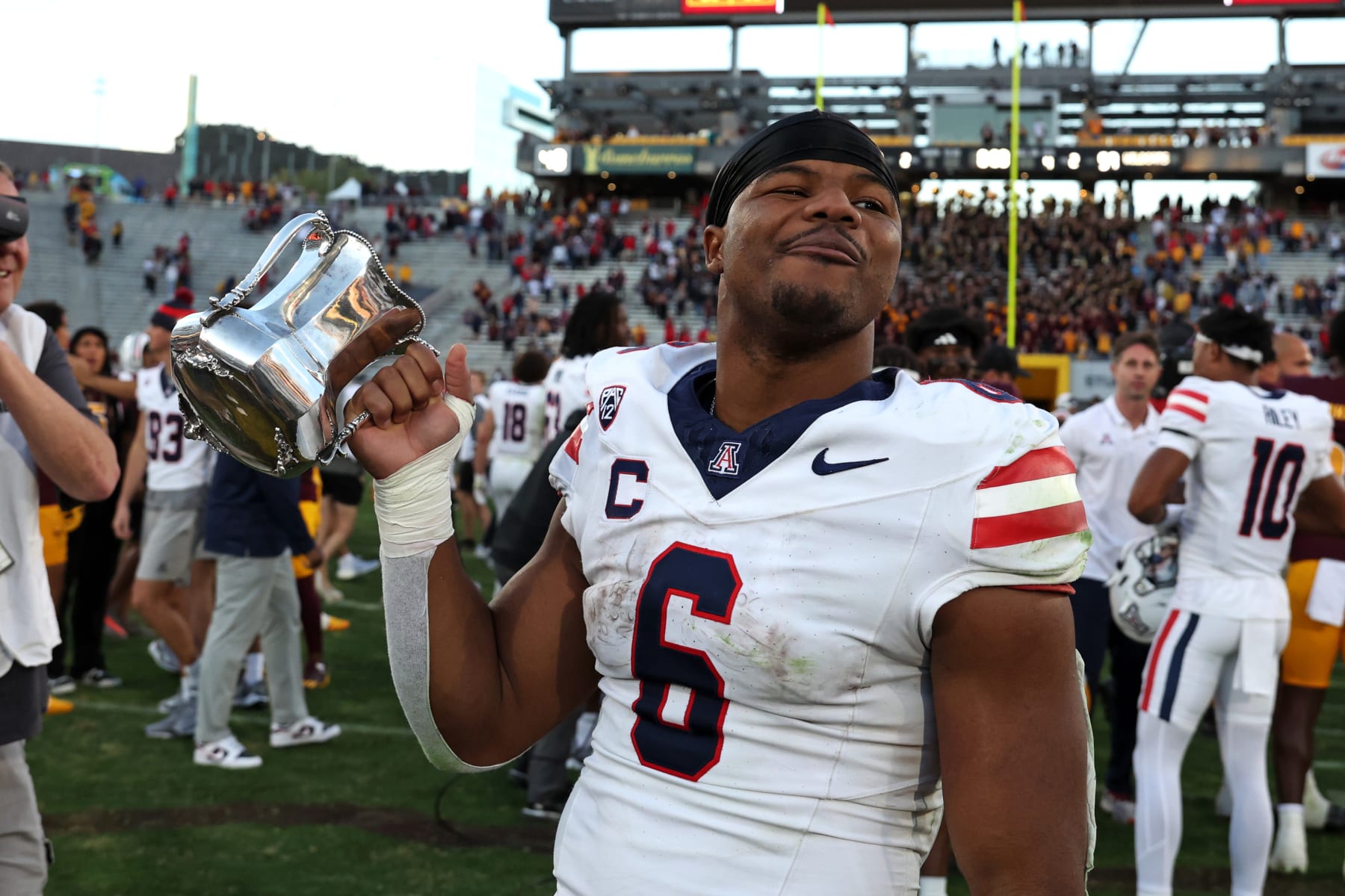 TEMPE, AZ - NOVEMBER 25: Arizona Wildcats running back Michael Wiley (6) celebrates with the Territorial Cup after a football game between the Arizona Wildcats and the Arizona State Sun Devils on November 25, 2023, at Mullett Arena in Tempe, AZ. (Photo by Zac BonDurant/Icon Sportswire via Getty Images)