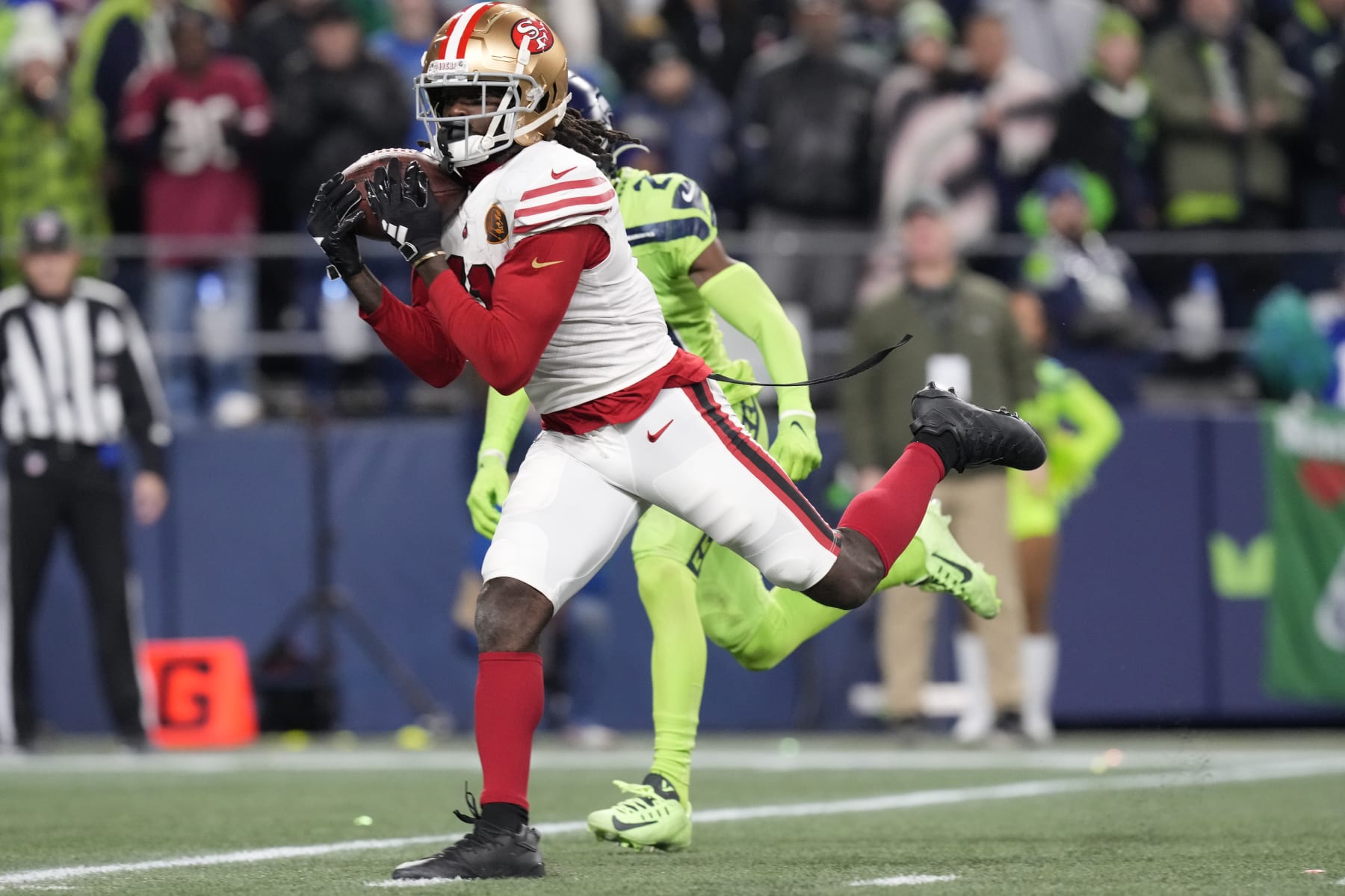 San Francisco 49ers wide receiver Brandon Aiyuk (11) catches a pass for a touchdown during an NFL football game against the Seattle Seahawks, Thursday, Nov. 23, 2023 in Seattle. The 49ers won 31-13. (AP Photo/Ben VanHouten)