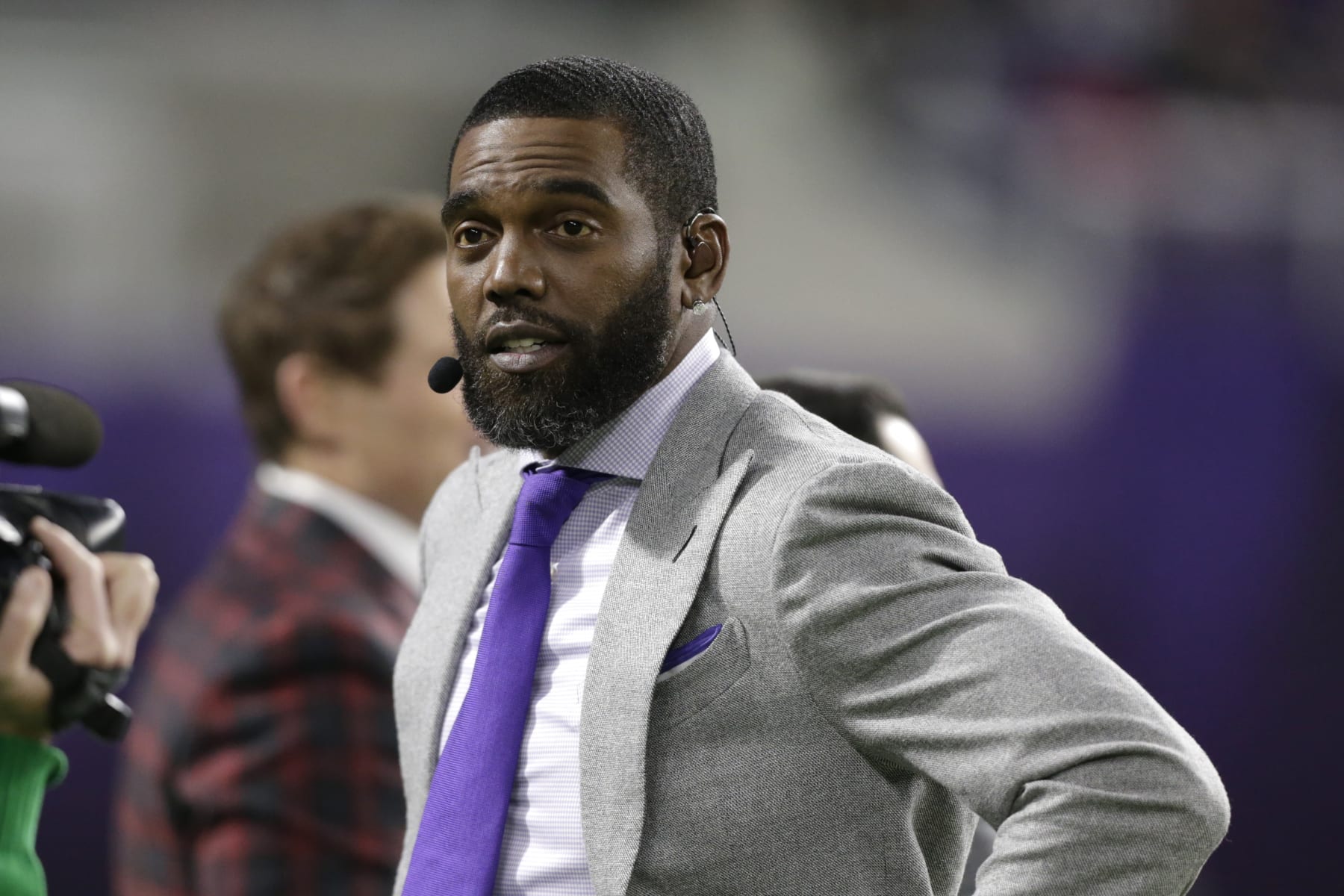 ESPN Monday Night Countdown personality Randy Moss stands on the field before an NFL football game between the Minnesota Vikings and the Green Bay Packers, Monday, Dec. 23, 2019, in Minneapolis. (AP Photo/Andy Clayton-King)
