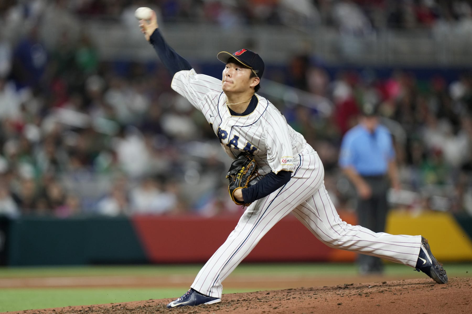 FILE - Japan's Yoshinobu Yamamoto delivers a pitch during the fifth inning of a World Baseball Classic game against Mexico on March 20, 2023, in Miami. Yamamoto already has a New York Yankees pinstripes with No. 18, the numeral prized by manager Japanese pitchers. “I gave him that jersey. It's his if he wants to keep it,” Yankees manager Aaron Boone said Thursday, Dec. 21, 2023. (AP Photo/Wilfredo Lee, File)