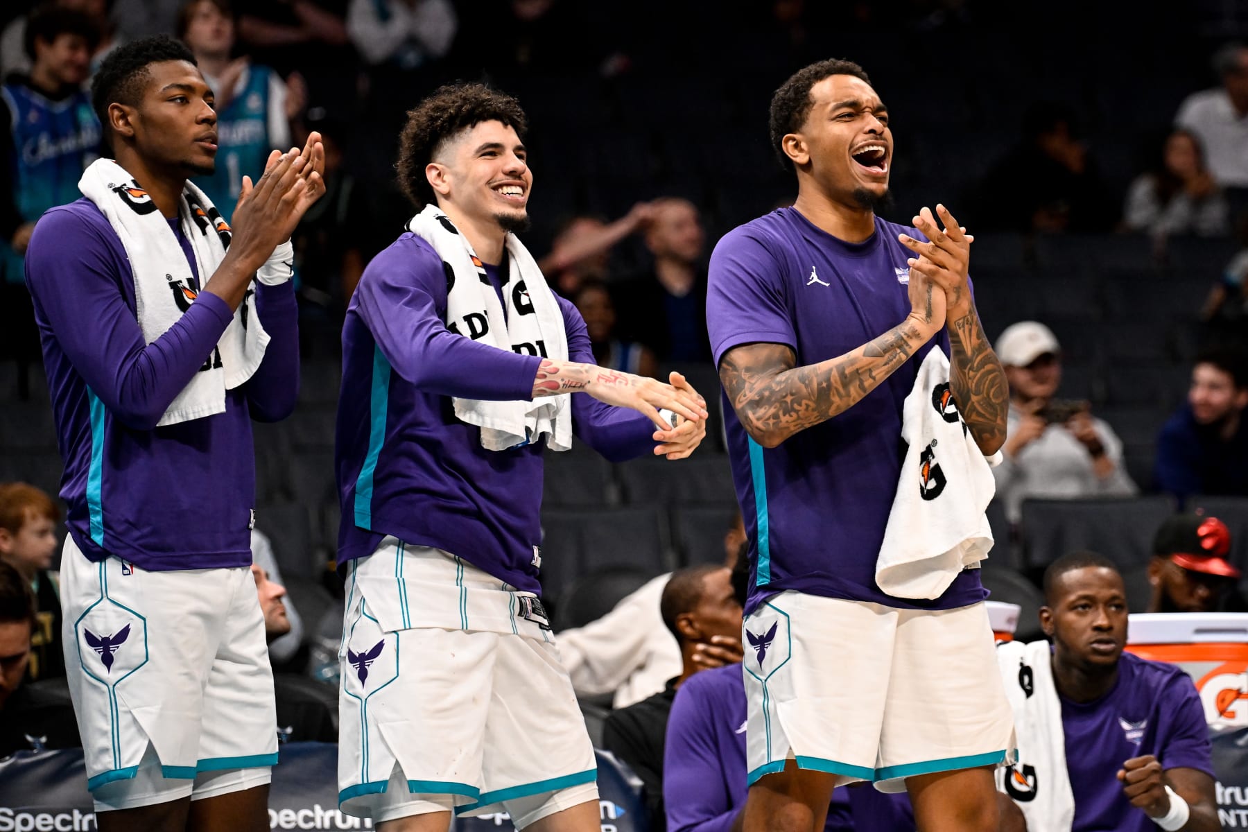 CHARLOTTE, NORTH CAROLINA - OCTOBER 15: (L-R) Brandon Miller #24, LaMelo Ball #1, and P.J. Washington #25 of the Charlotte Hornets cheer during the second half of their game against the Oklahoma City Thunder2 at Spectrum Center on October 15, 2023 in Charlotte, North Carolina. NOTE TO USER: User expressly acknowledges and agrees that, by downloading and or using this photograph, User is consenting to the terms and conditions of the Getty Images License Agreement. (Photo by Matt Kelley/Getty Images)