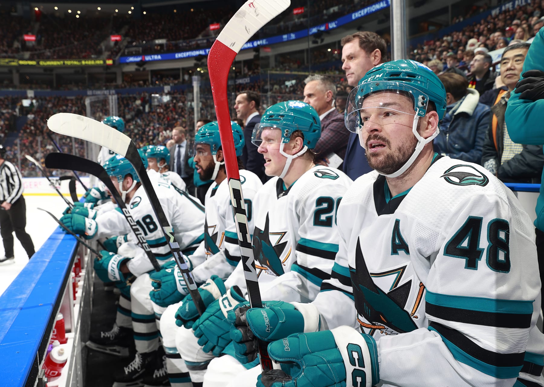 VANCOUVER, CANADA - DECEMBER 23: Tomas Hertl #48 of the San Jose Sharks looks on from the bench during their NHL game against the Vancouver Canucks at Rogers Arena on December 23, 2023 in Vancouver, British Columbia, Canada. (Photo by Jeff Vinnick/NHLI via Getty Images)