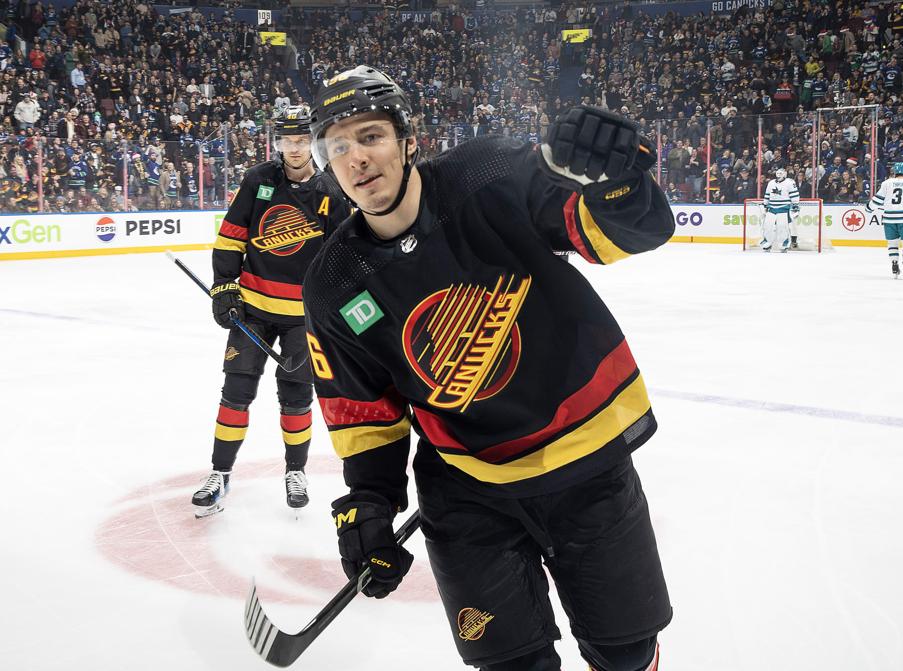 VANCOUVER, CANADA - DECEMBER 23: Andrei Kuzmenko #96 of the Vancouver Canucks skates back to the bench to celebrate his goal with teammates during the first period of their NHL game against the San Jose Sharks at Rogers Arena on December 23, 2023 in Vancouver, British Columbia, Canada. (Photo by Jeff Vinnick/NHLI via Getty Images)