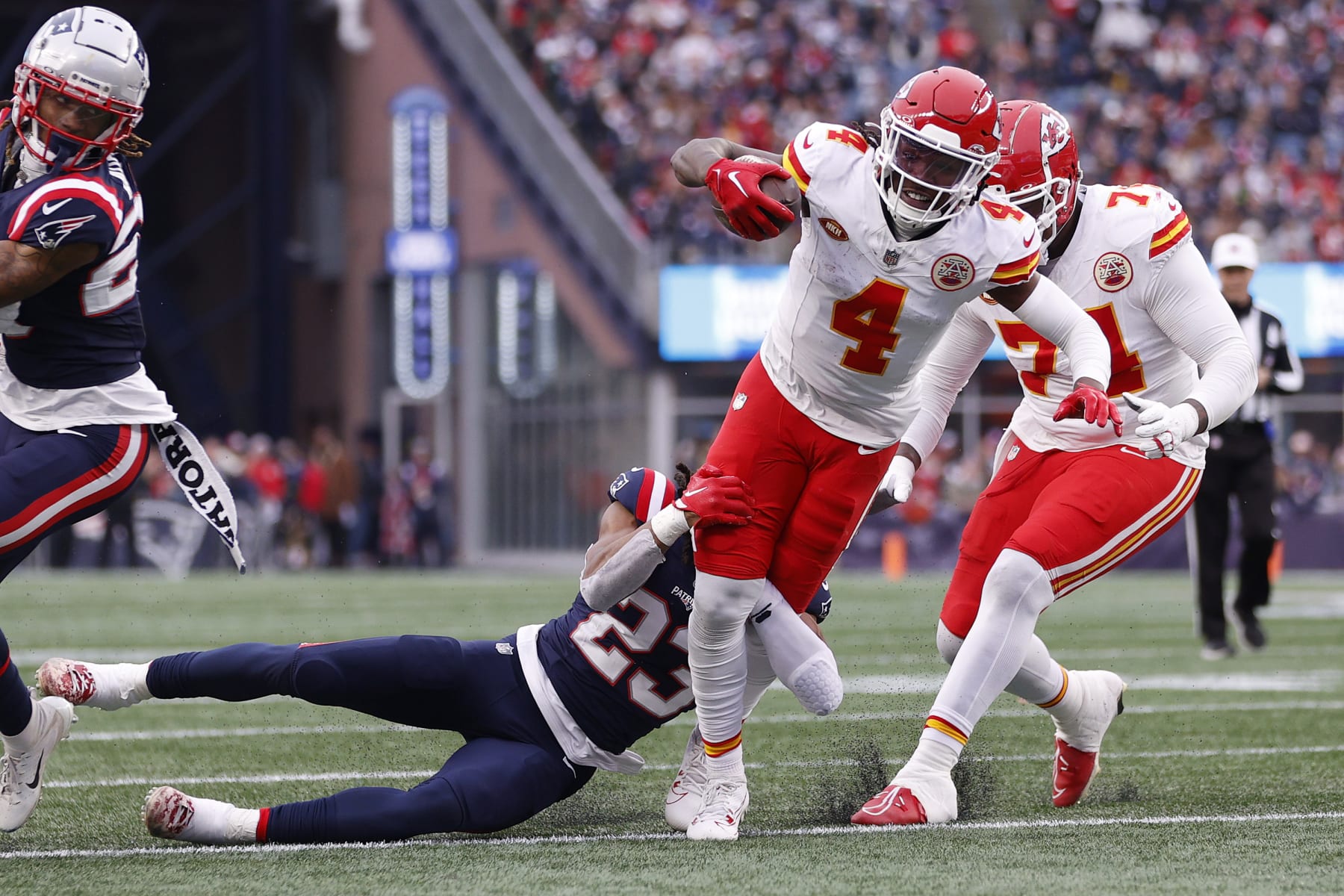 FOXBOROUGH, MASSACHUSETTS - DECEMBER 17: Kyle Dugger #23 of the New England Patriots tackles Rashee Rice #4 of the Kansas City Chiefs during the first half at Gillette Stadium on December 17, 2023 in Foxborough, Massachusetts. (Photo by Sarah Stier/Getty Images)
