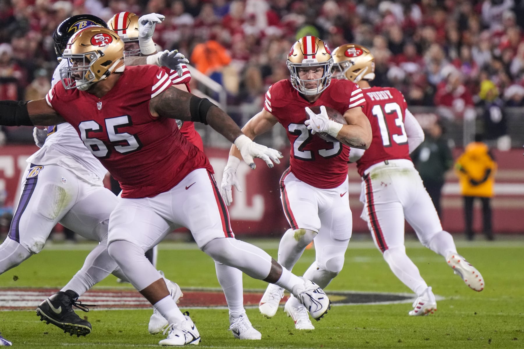 SANTA CLARA, CALIFORNIA - DECEMBER 25: Christian McCaffrey #23 of the San Francisco 49ers runs the ball during the first half against the Baltimore Ravens at Levi's Stadium on December 25, 2023 in Santa Clara, California. (Photo by Loren Elliott/Getty Images)