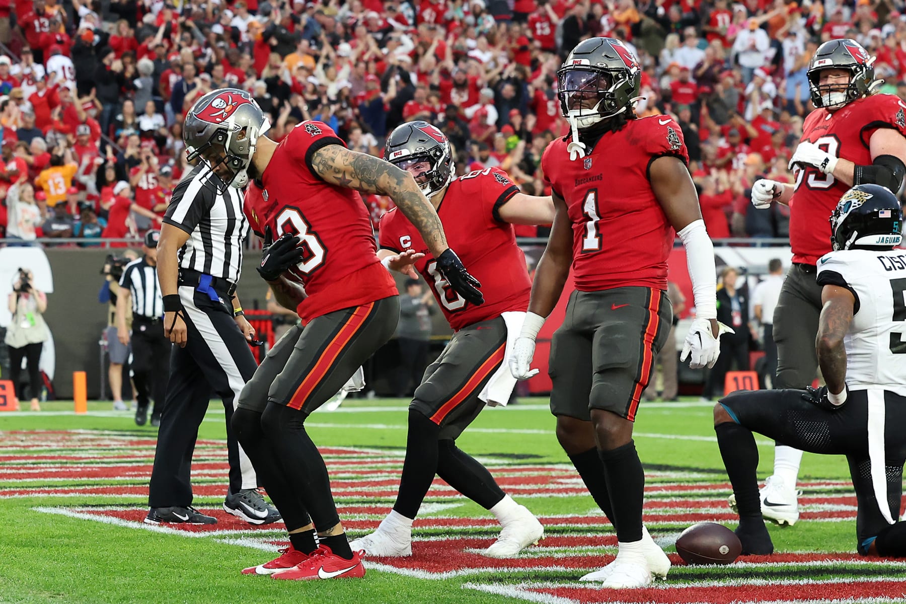TAMPA, FLORIDA - DECEMBER 24: Mike Evans #13 of the Tampa Bay Buccaneers celebrates with his teammates after scoring his second touchdown reception of the second quarter against the Jacksonville Jaguars at Raymond James Stadium on December 24, 2023 in Tampa, Florida. (Photo by Mike Carlson/Getty Images)