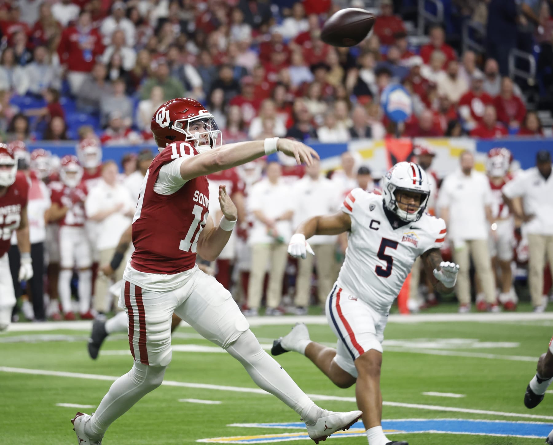 SAN ANTONIO, TX - DECEMBER 28:  Arnold Jackson #10 of the Oklahoma Sooners throws a pass against the Arizona Wildcats in the first half at the Valero Alamo Bowl at the Alamodome on December  28, 2023 in San Antonio, Texas.  (Photo by Ronald Cortes/Getty Images)