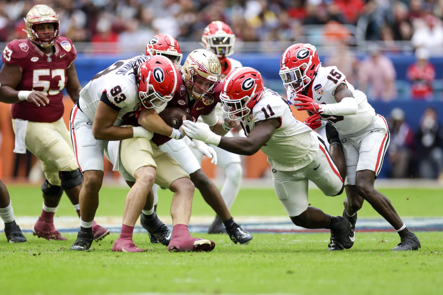 MIAMI GARDENS, FL - DECEMBER 30: Florida State Seminoles quarterback Brock Glenn (11) is tackled by Georgia Bulldogs defensive lineman Tyrion Ingram-Dawkins (93) and Georgia Bulldogs linebacker Jalon Walker (11) during the game between the Georgia Bulldogs and the Florida State Seminoles on December 30, 2023 at Hard Rock Stadium in Miami Gardens, Fl.  (Photo by David Rosenblum/Icon Sportswire via Getty Images)