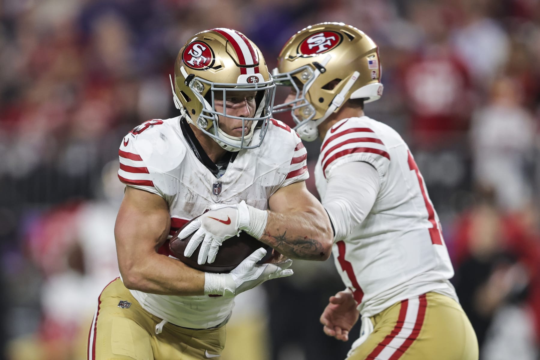 MINNEAPOLIS, MINNESOTA - OCTOBER 23: Brock Purdy #13 of the San Francisco 49ers hands the ball off to Christian McCaffrey #23 of the San Francisco 49ers during an NFL football game between the Minnesota Vikings and the San Francisco 49ers at U.S. Bank Stadium on October 23, 2023 in Minneapolis, Minnesota. (Photo by Michael Owens/Getty Images)