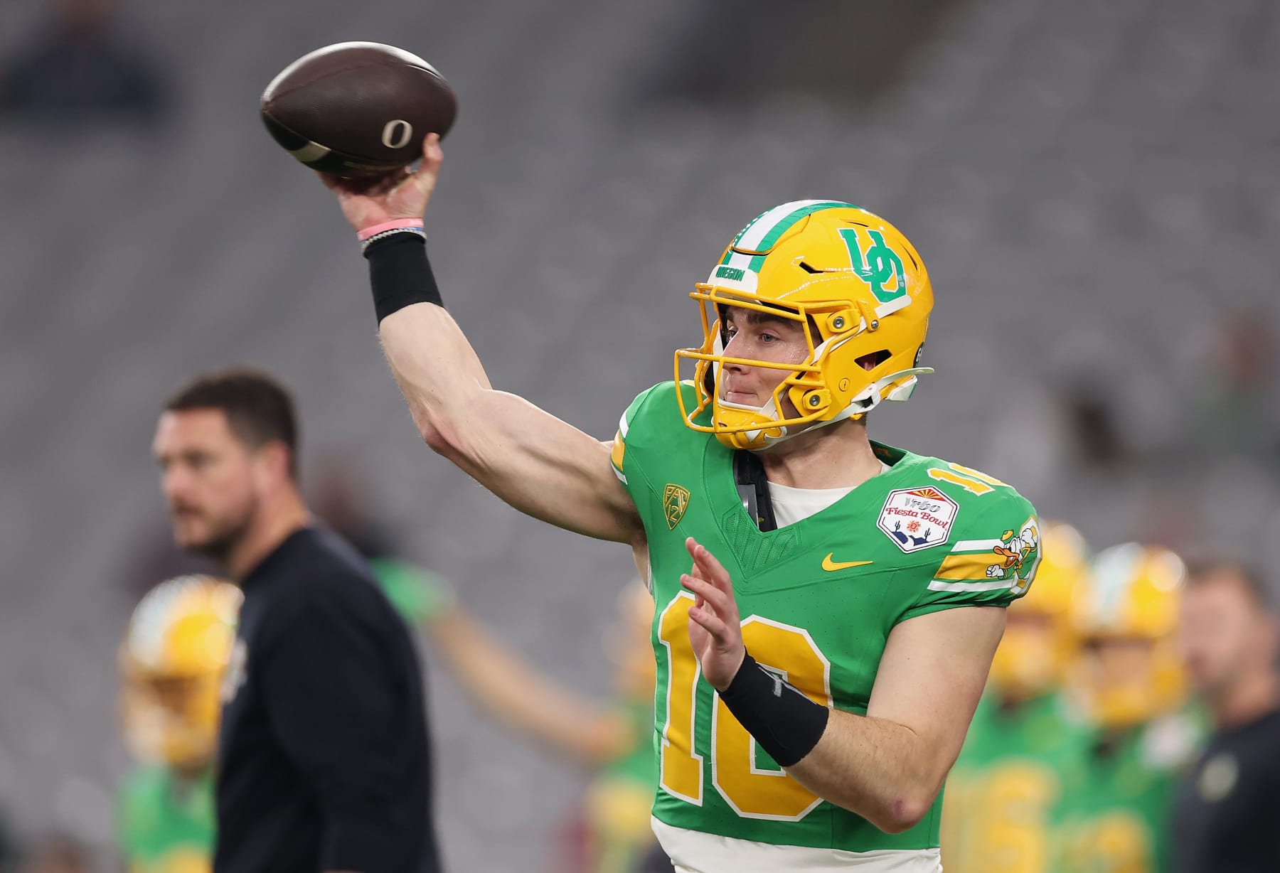 GLENDALE, ARIZONA - JANUARY 01: Quarterback Bo Nix #10 of the Oregon Ducks warms up before the Fiesta Bowl against the Liberty Flames at State Farm Stadium on January 01, 2024 in Glendale, Arizona. (Photo by Christian Petersen/Getty Images)