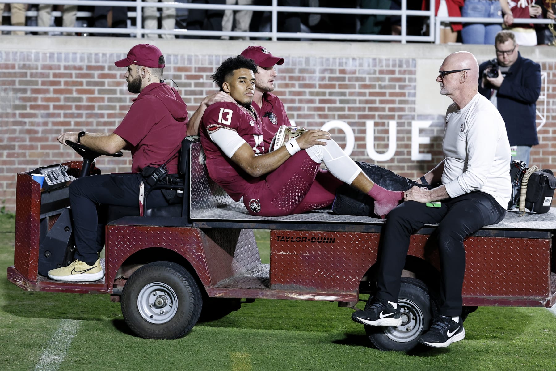 TALLAHASSEE, FL - NOVEMBER 18: Quarterback Jordan Travis #13 of the Florida State Seminoles is carted off the field after an ankle jury during the game against the North Alabama Lions on Bobby Bowden Field at Doak Campbell Stadium on November 18, 2023 in Tallahassee, Florida. The 4th ranked Seminoles defeated the Lions 58 to 13. (Photo by Don Juan Moore/Getty Images)