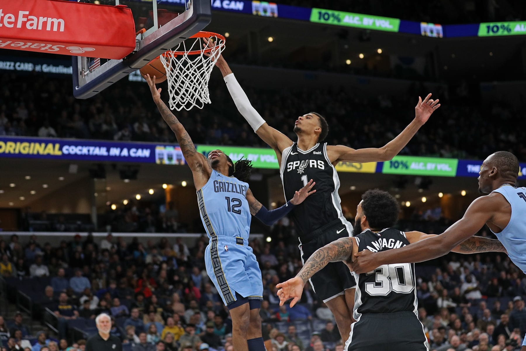 MEMPHIS, TENNESSEE - JANUARY 02: Ja Morant #12 of the Memphis Grizzlies goes to the basket against Victor Wembanyama #1 of the San Antonio Spurs during the first half at FedExForum on January 02, 2024 in Memphis, Tennessee. NOTE TO USER: User expressly acknowledges and agrees that, by downloading and or using this photograph, User is consenting to the terms and conditions of the Getty Images License Agreement. (Photo by Justin Ford/Getty Images)