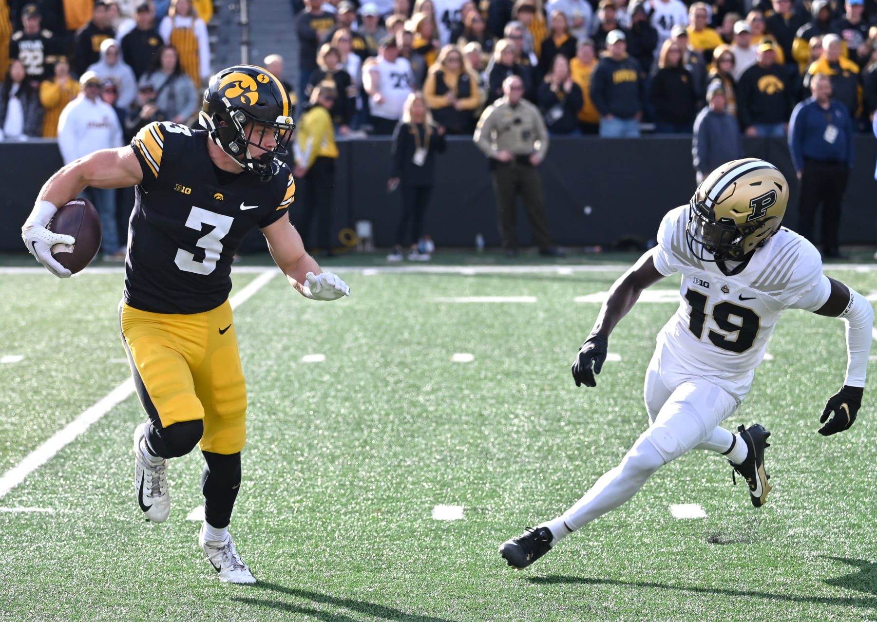 IOWA CITY, IA - OCTOBER 07: Iowa Hawkeyes left corner back Cooper DeJean (3) runs back a uni as Purdue defensive back Botros Alisandro (19) defends  during a college football game between the Purdue Boilermakers and the Iowa Hawkeyes on October 07, 2023, at Kinnick Stadium in Iowa City, Ia. (Photo by Keith Gillett/Icon Sportswire via Getty Images)