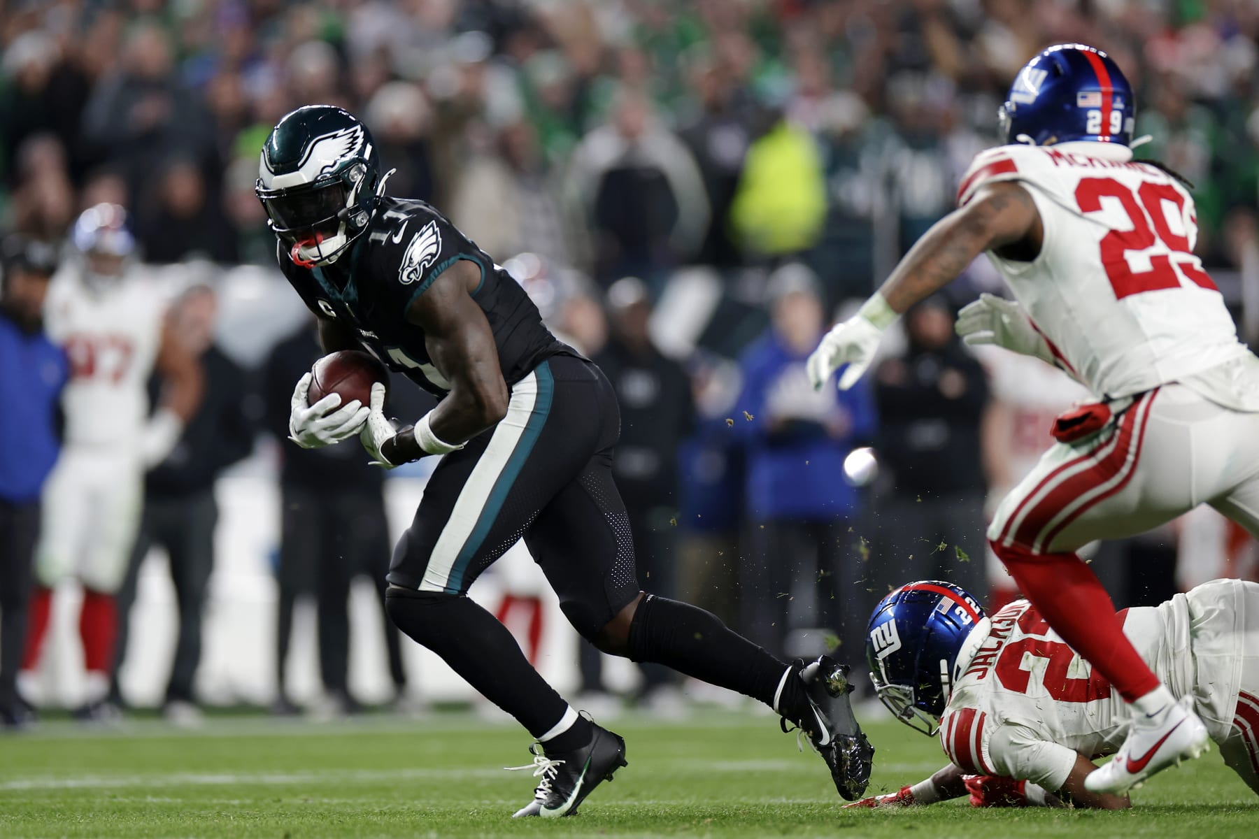 PHILADELPHIA, PENNSYLVANIA - DECEMBER 25: A.J. Brown #11 of the Philadelphia Eagles runs the ball against Adoree' Jackson #22 and Xavier McKinney #29 of the New York Giants during the fourth quarter at Lincoln Financial Field on December 25, 2023 in Philadelphia, Pennsylvania. (Photo by Adam Hunger/Getty Images)