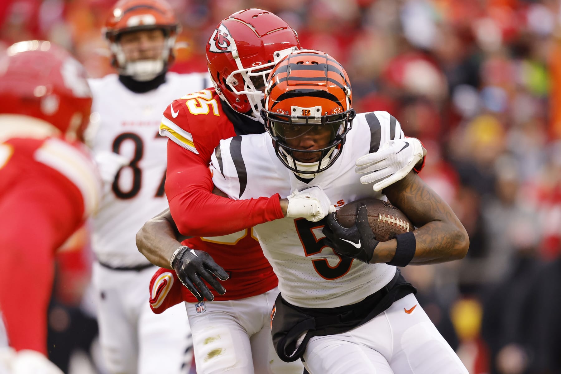KANSAS CITY, MISSOURI - DECEMBER 31: Tee Higgins #5 of the Cincinnati Bengals is tackled by Jaylen Watson #35 of the Kansas City Chiefs during the first quarter at GEHA Field at Arrowhead Stadium on December 31, 2023 in Kansas City, Missouri. (Photo by David Eulitt/Getty Images)