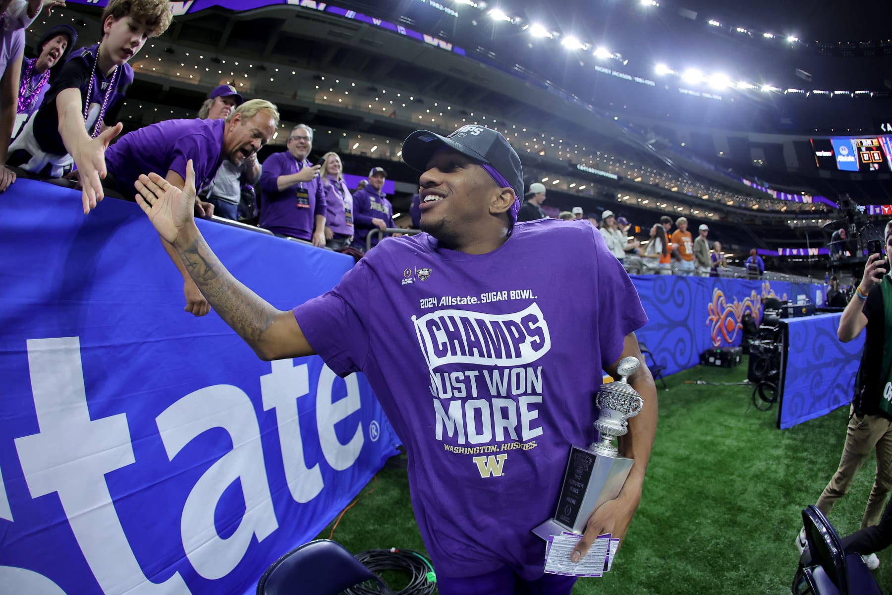 NEW ORLEANS, LOUISIANA - JANUARY 01: Michael Penix Jr. #9 of the Washington Huskies celebrates with fans after a 37-31 victory against the Texas Longhorns in the CFP Semifinal Allstate Sugar Bowl at Caesars Superdome on January 01, 2024 in New Orleans, Louisiana. (Photo by Jonathan Bachman/Getty Images)