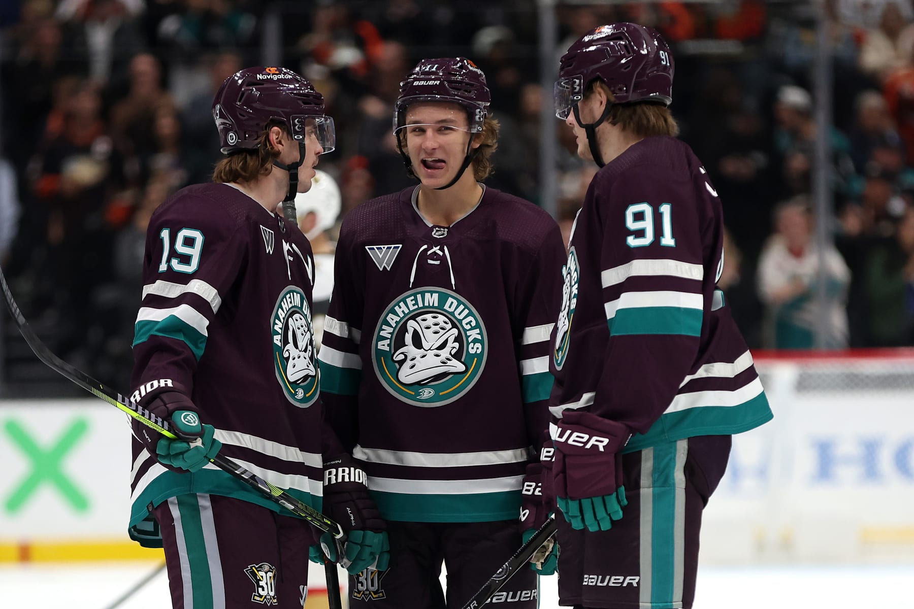ANAHEIM, CALIFORNIA - NOVEMBER 05: Troy Terry #19, Leo Carlsson #91, and Trevor Zegras #11 of the Anaheim Ducks talk during a timeout in the second period of a game against the Vegas Golden Knights at Honda Center on November 05, 2023 in Anaheim, California. (Photo by Sean M. Haffey/Getty Images)