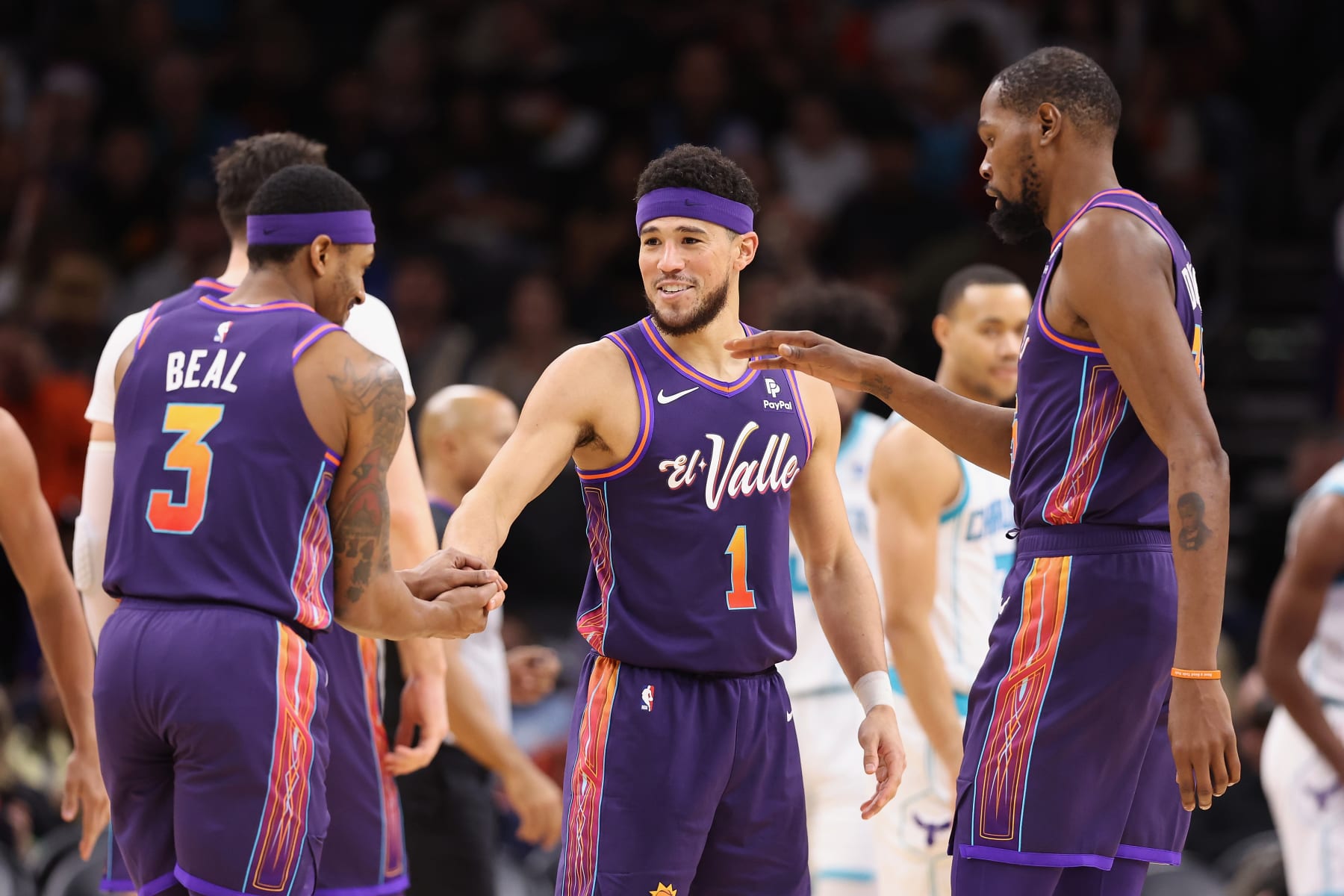 PHOENIX, ARIZONA - DECEMBER 29: Devin Booker #1 of the Phoenix Suns celebrates with Bradley Beal #3 and Kevin Durant #35 after scoring against the Charlotte Hornetsduring the second half of the NBA game at Footprint Center on December 29, 2023 in Phoenix, Arizona. NOTE TO USER: User expressly acknowledges and agrees that, by downloading and or using this photograph, User is consenting to the terms and conditions of the Getty Images License Agreement. (Photo by Christian Petersen/Getty Images)