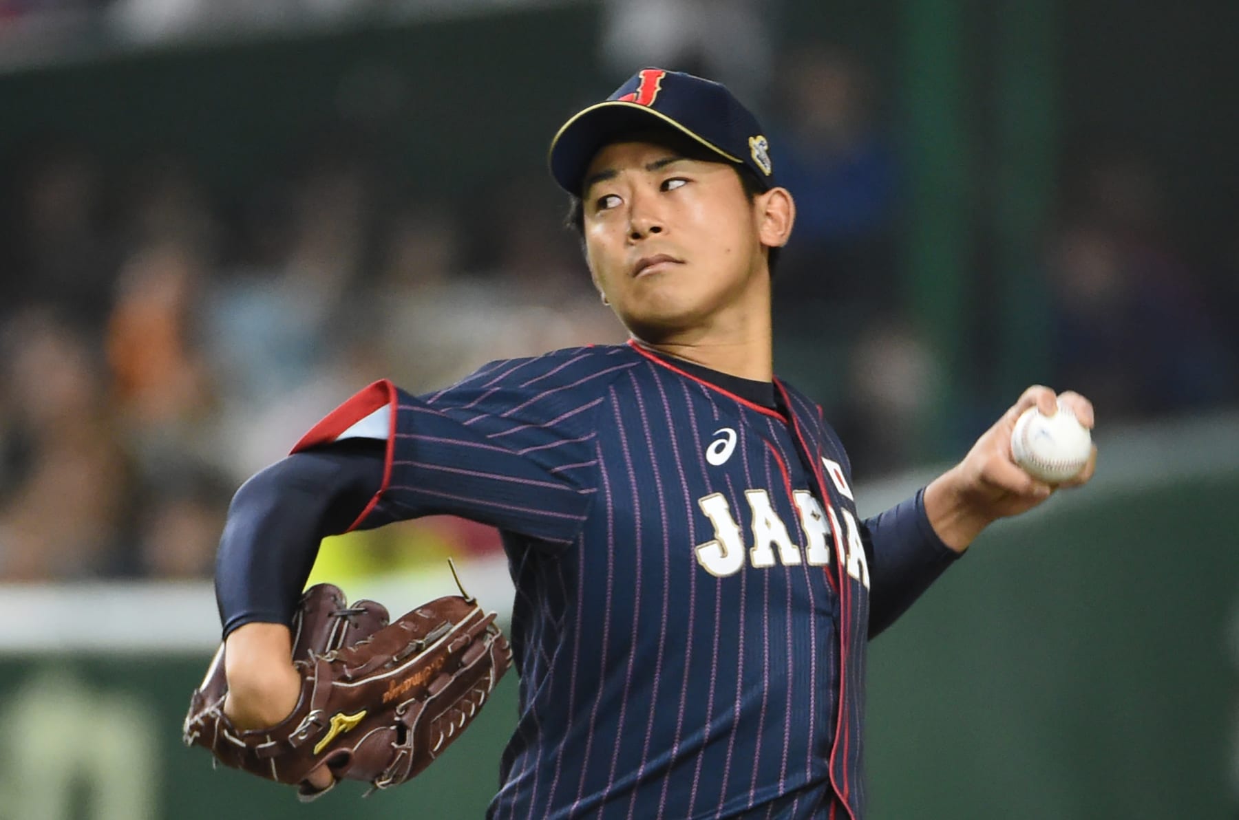 Japan's starting pitcher Shota Imanaga pitches against Taiwan in the first inning during the Asia Professional Baseball Championships preliminary round match between Japan and Taiwan at the Tokyo Dome in Tokyo on November 18, 2017. / AFP PHOTO / Kazuhiro NOGI (Photo credit should read KAZUHIRO NOGI/AFP via Getty Images)