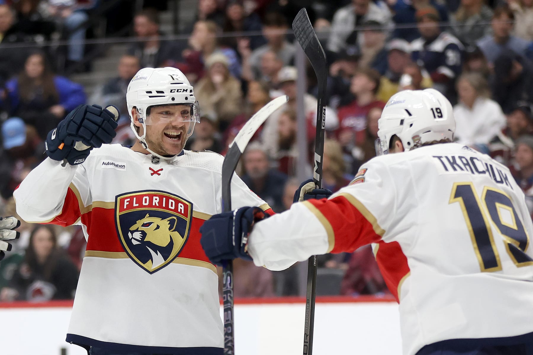 DENVER, COLORADO - JANUARY 06: Sam Reinhart #13 of the Florida Panthers celebrates with Matthew Tkachuk #19 after scoring against the Colorado Avalanche in the third period at Ball Arena on January 06, 2024 in Denver, Colorado. (Photo by Matthew Stockman/Getty Images)