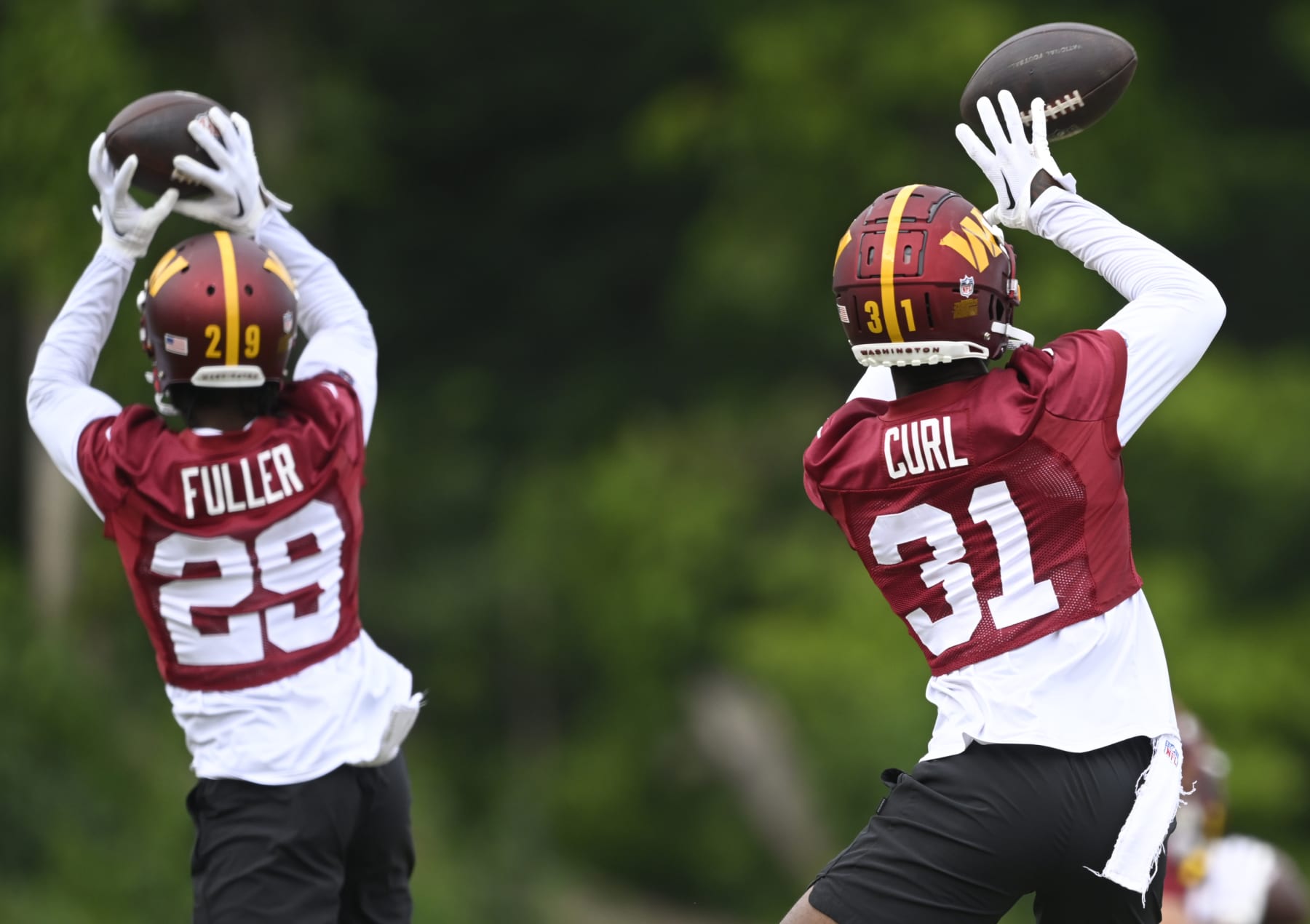ASHBURN , VA - AUGUST 3: Washington Commanders cornerback Kendall Fuller (29), left, and safety Kamren Curl (31) drill together during day 9 at the Washington Commanders training camp at Commanders Park on August 3, 2023 in Ashburn, VA. (Photo by John McDonnell/The Washington Post via Getty Images)