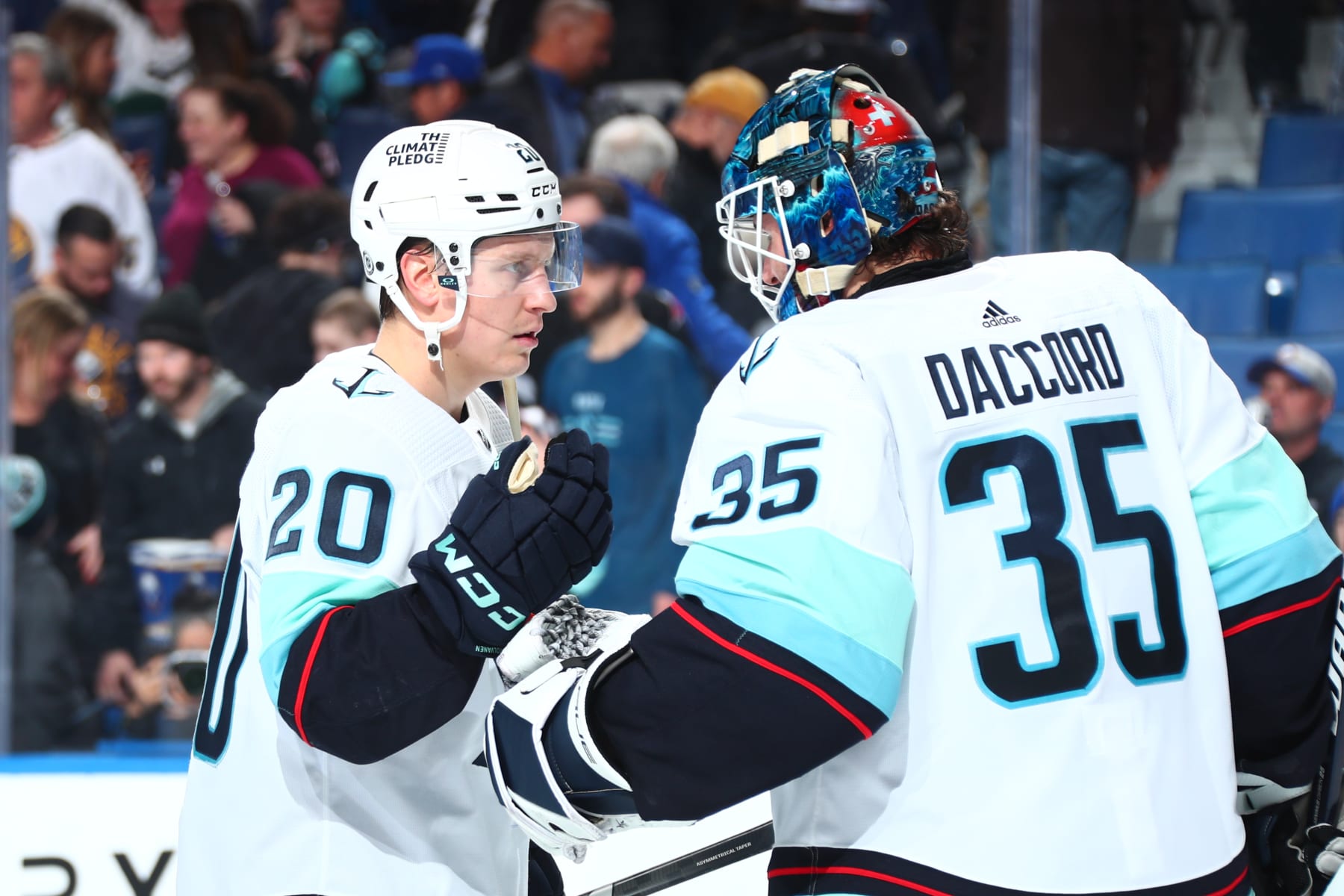BUFFALO, NEW YORK - JANUARY 9: Eeli Tolvanen #20 celebrates with Joey Daccord #35 of the Seattle Kraken after an NHL game against the Buffalo Sabres on January 9, 2024 at KeyBank Center in Buffalo, New York. Seattle won, 5-2. (Photo by Bill Wippert/NHLI via Getty Images)