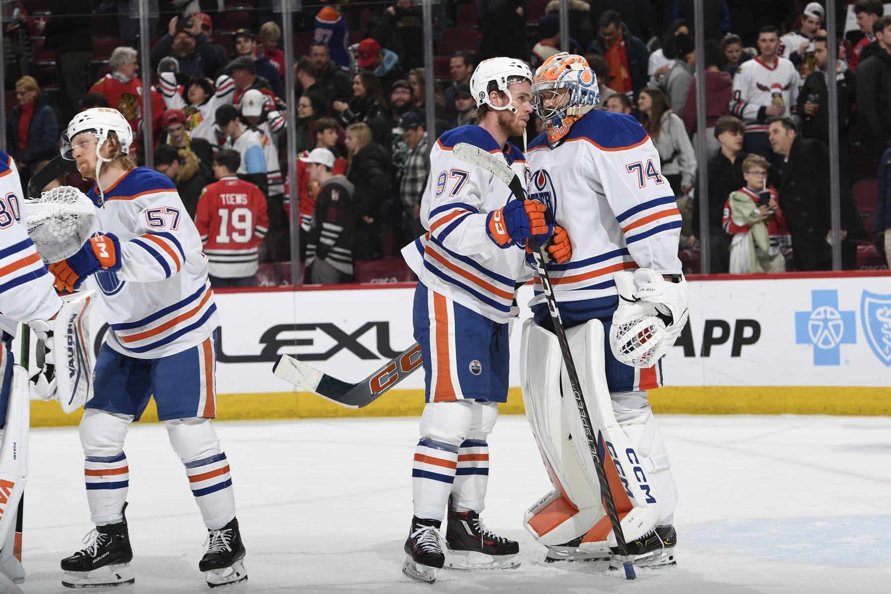 CHICAGO, ILLINOIS - JANUARY 09: Connor McDavid #97 of the Edmonton Oilers celebrates with teammate goalie Stuart Skinner #74 after defeating the Chicago Blackhawks 2-1 at the United Center on January 09, 2024 in Chicago, Illinois. (Photo by Bill Smith/NHLI via Getty Images)