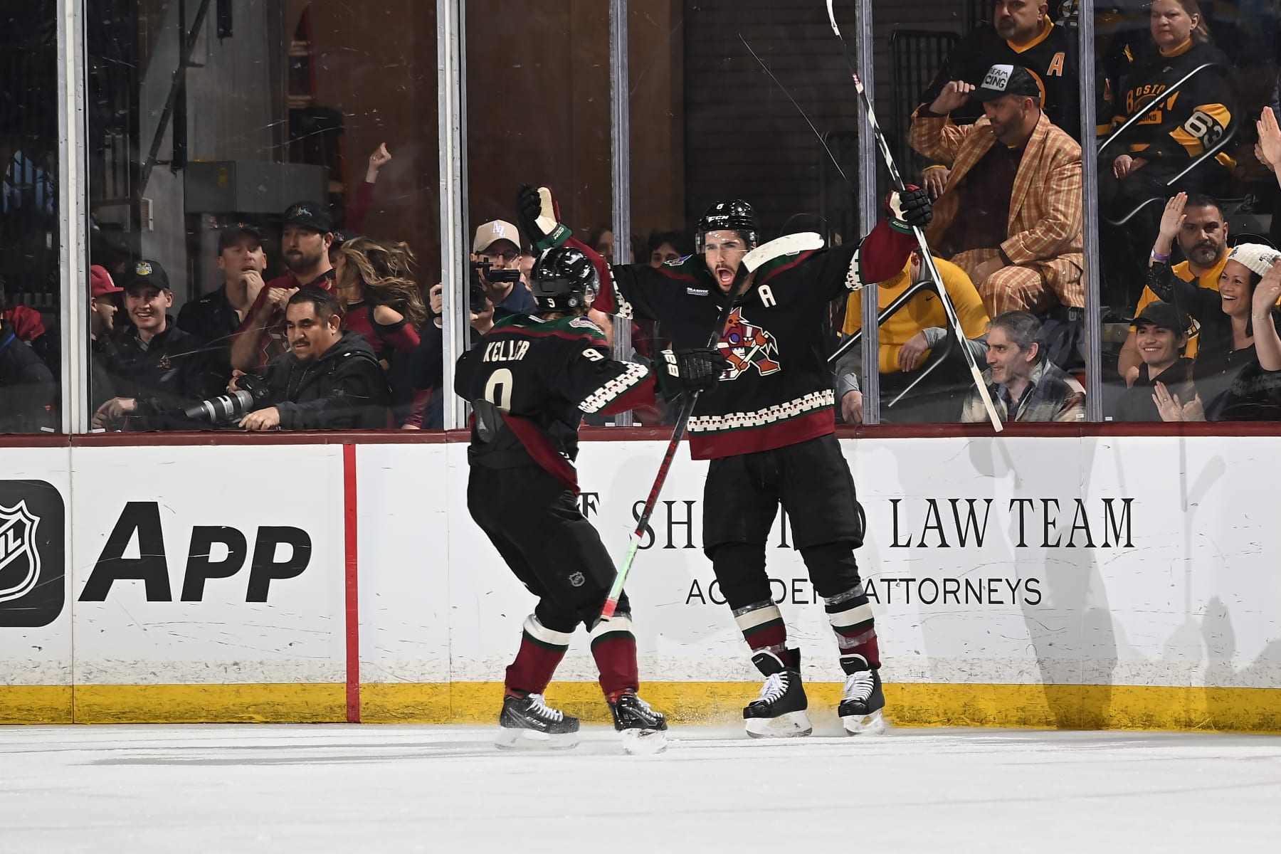 TEMPE, ARIZONA - JANUARY 09: Nick Schmaltz #8 of the Arizona Coyotes celebrates with teammate Clayton Keller #9 afte scoring a goal in overtime to defeat the Boston Bruins 4-3 at Mullett Arena on January 09, 2024 in Tempe, Arizona. (Photo by Norm Hall/NHLI via Getty Images)