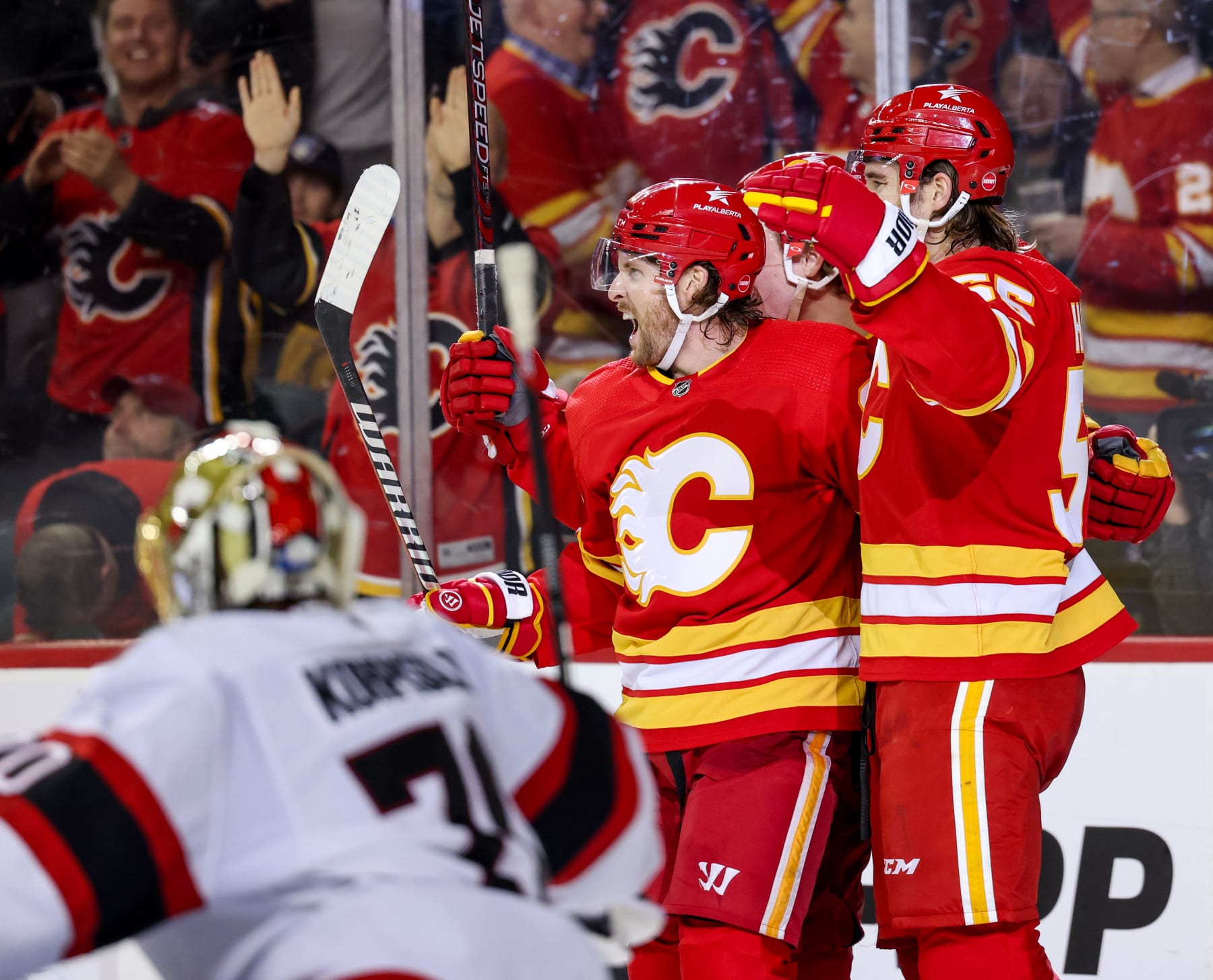 CALGARY, CANADA - JANUARY 9: Blake Coleman #20 of the Calgary Flames celebrates his goal on the Ottawa Senators with teammates Noah Hanifin #55 of the Calgary Flames during the third period at the Scotiabank Saddledome on January 9, 2024 in Calgary, Alberta, Canada. (Photo by Leah Hennel/Getty Images)