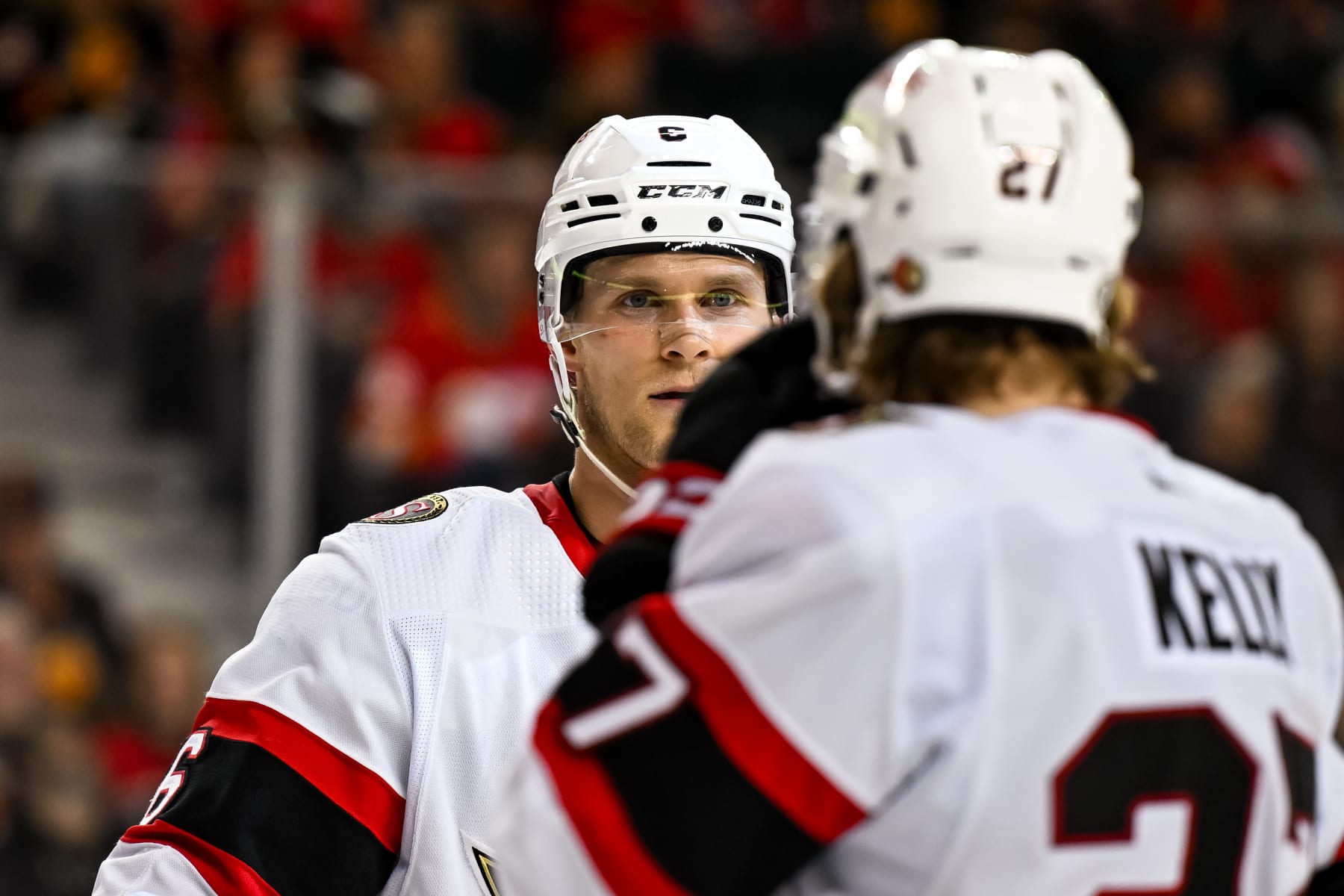 CALGARY, AB - JANUARY 09: Ottawa Senators Defenceman Jakob Chychrun (6) and Ottawa Senators Right Wing Parker Kelly (27) talk before a face-off during the first period of an NHL game between the Calgary Flames and the Ottawa Senators on January 9, 2024, at the Scotiabank Saddledome in Calgary, AB. (Photo by Brett Holmes/Icon Sportswire via Getty Images)