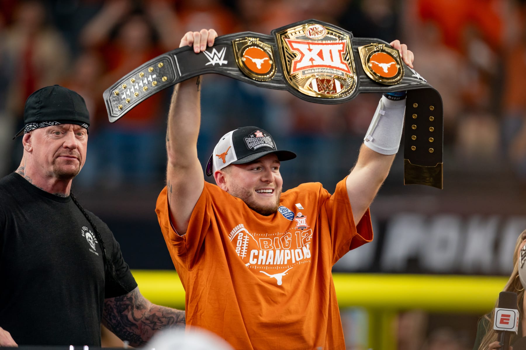 ARLINGTON, TX - DECEMBER 02: Texas Longhorns quarterback Quinn Ewers (3) holds up the WWE Big 12 Championship belt after winning the Big 12 Championship game between the Texas Longhorns and the Oklahoma State Cowboys on December 02, 2023 at AT&T Stadium in Arlington, TX. (Photo by Chris Leduc/Icon Sportswire via Getty Images)