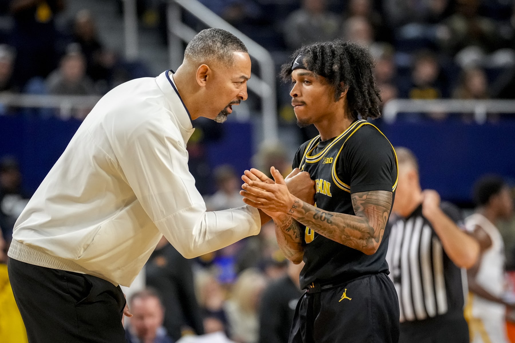 Michigan's Dug McDaniel and Juwan Howard