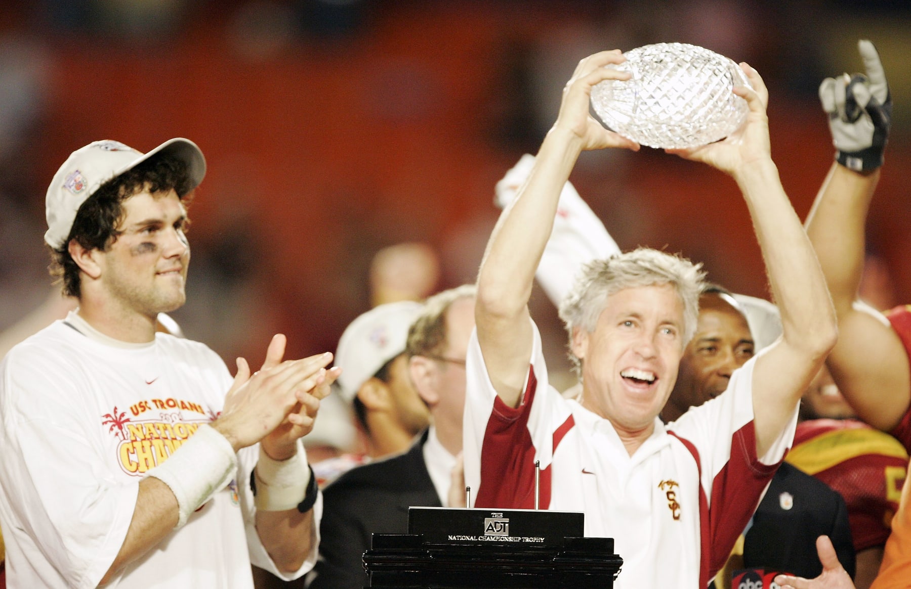 MIAMI - JANUARY 4: Head coach Pete Carroll of the USC Trojans holds up the championship trophy as quarterback Matt Leinart #11 celebrates after defeating the Oklahoma Sooners 55-19 to win the FedEx Orange Bowl 2005 National Championship on January 4, 2005 at Pro Player Stadium in Miami, Florida. (Photo by Brian Bahr/Getty Images)