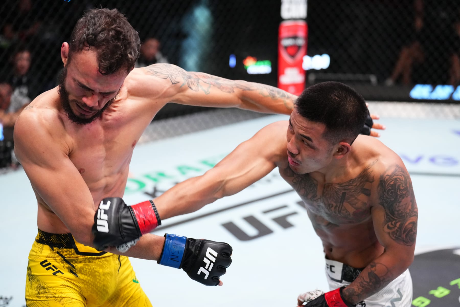LAS VEGAS, NEVADA - JANUARY 13: (R-L) Joshua Van of Myanmar punches Felipe Bunes of Brazil in a flyweight fight during the UFC Fight Night event at UFC APEX on January 13, 2024 in Las Vegas, Nevada. (Photo by Chris Unger/Zuffa LLC via Getty Images)