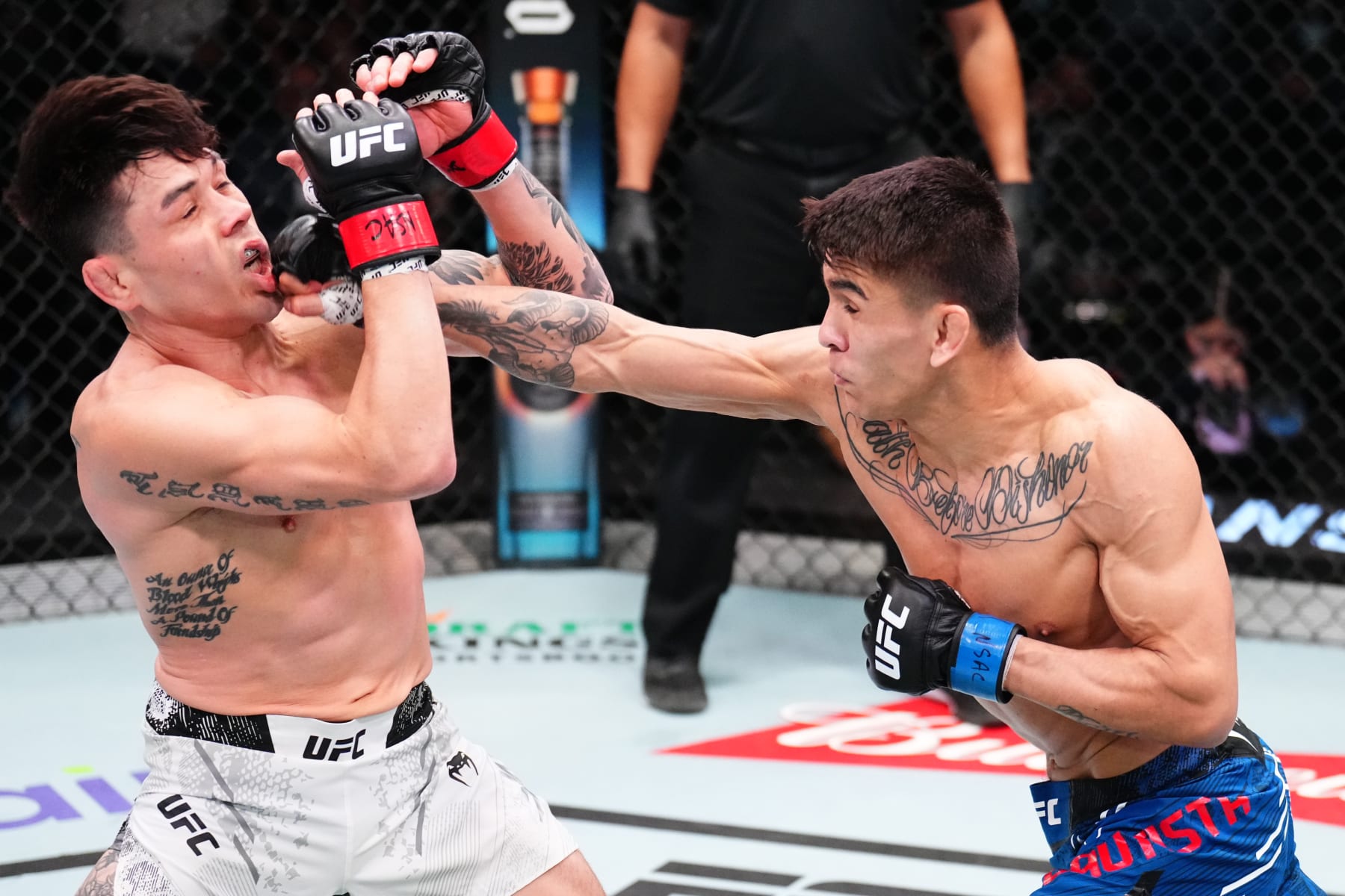 LAS VEGAS, NEVADA - JANUARY 13: (R-L) Mario Bautista punches Ricky Simon in a bantamweight fight during the UFC Fight Night event at UFC APEX on January 13, 2024 in Las Vegas, Nevada. (Photo by Chris Unger/Zuffa LLC via Getty Images)